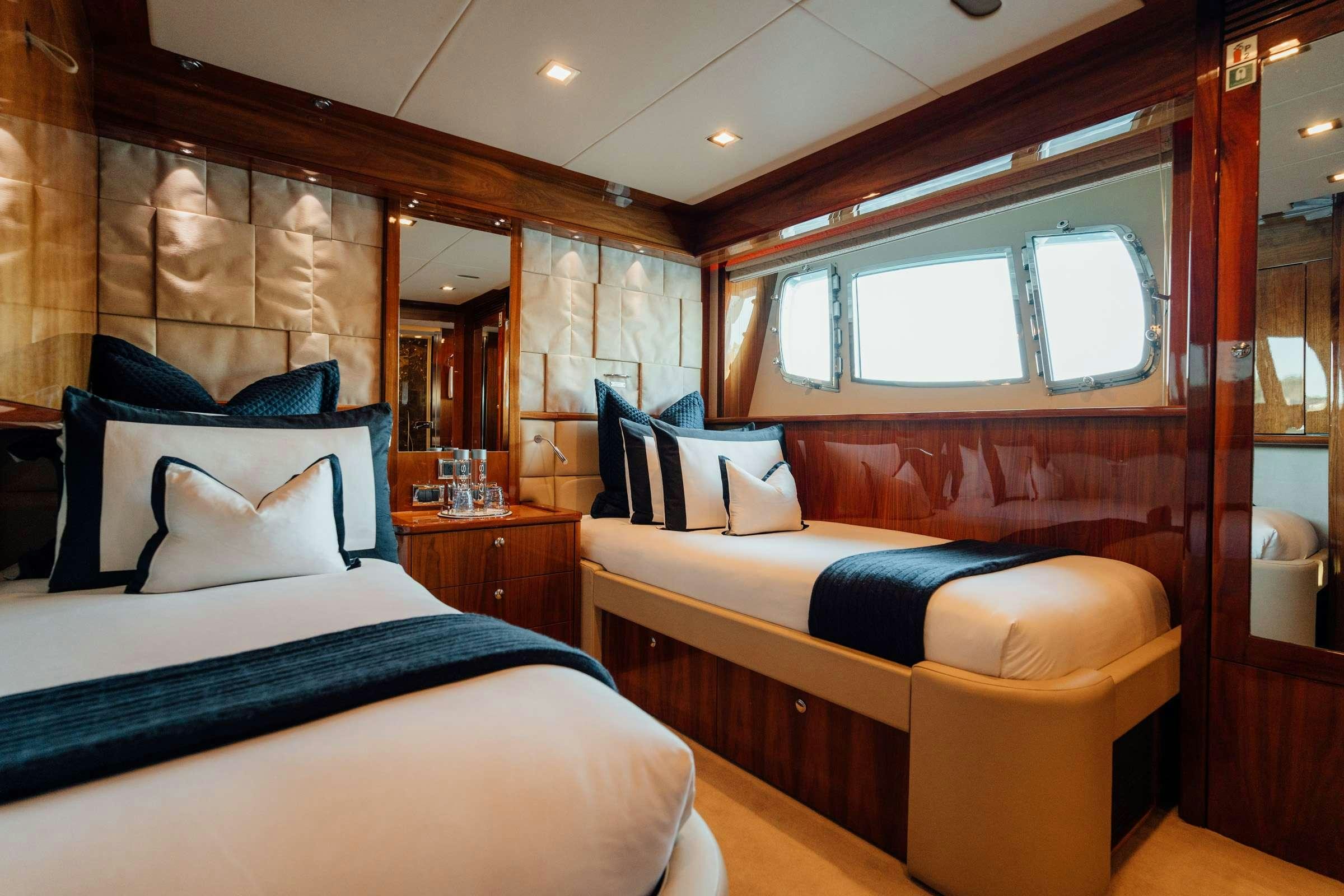 a room with a bed and a couch aboard CHAOS Yacht for Charter