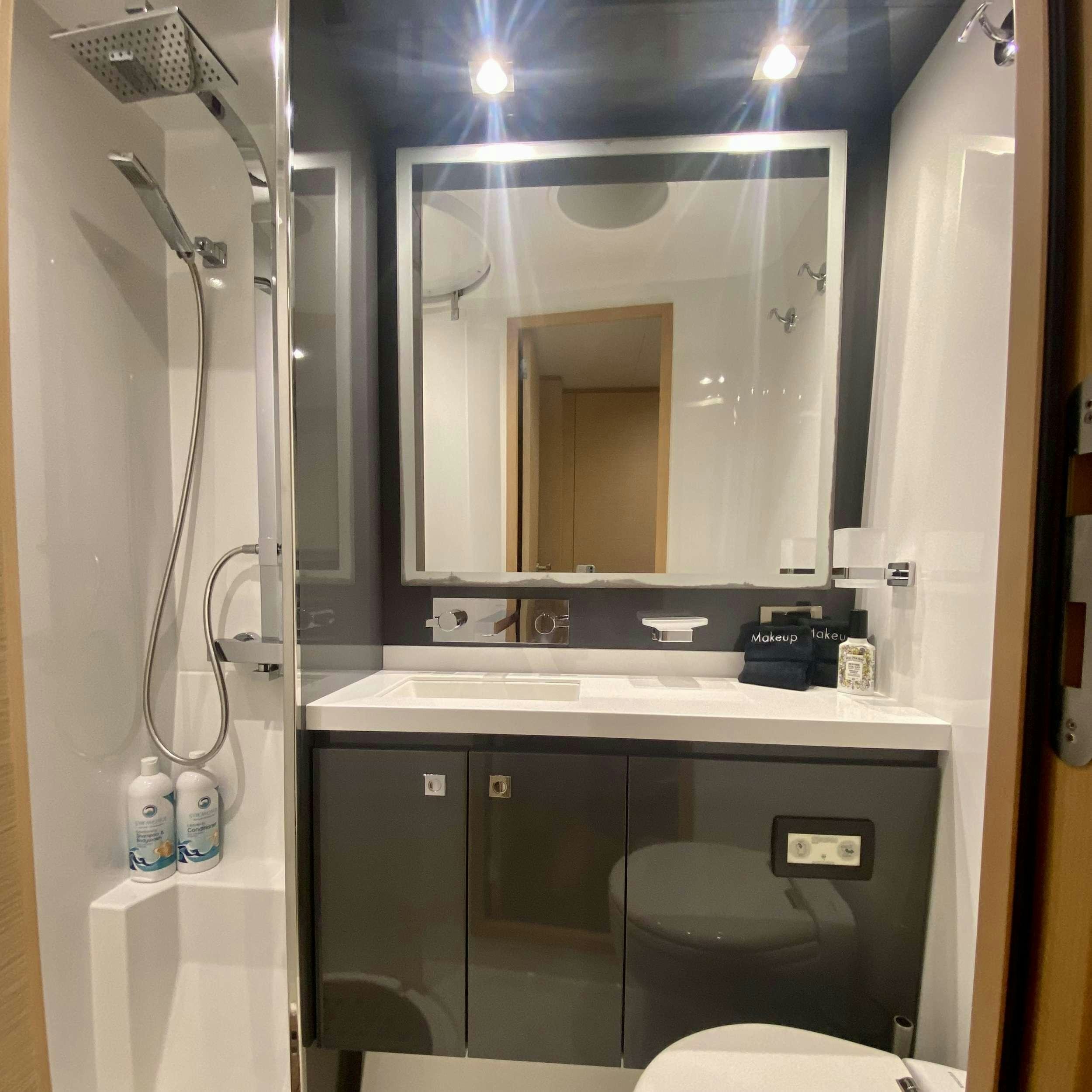 a bathroom with a large mirror aboard SOME KIND OF WONDERFUL Yacht for Charter