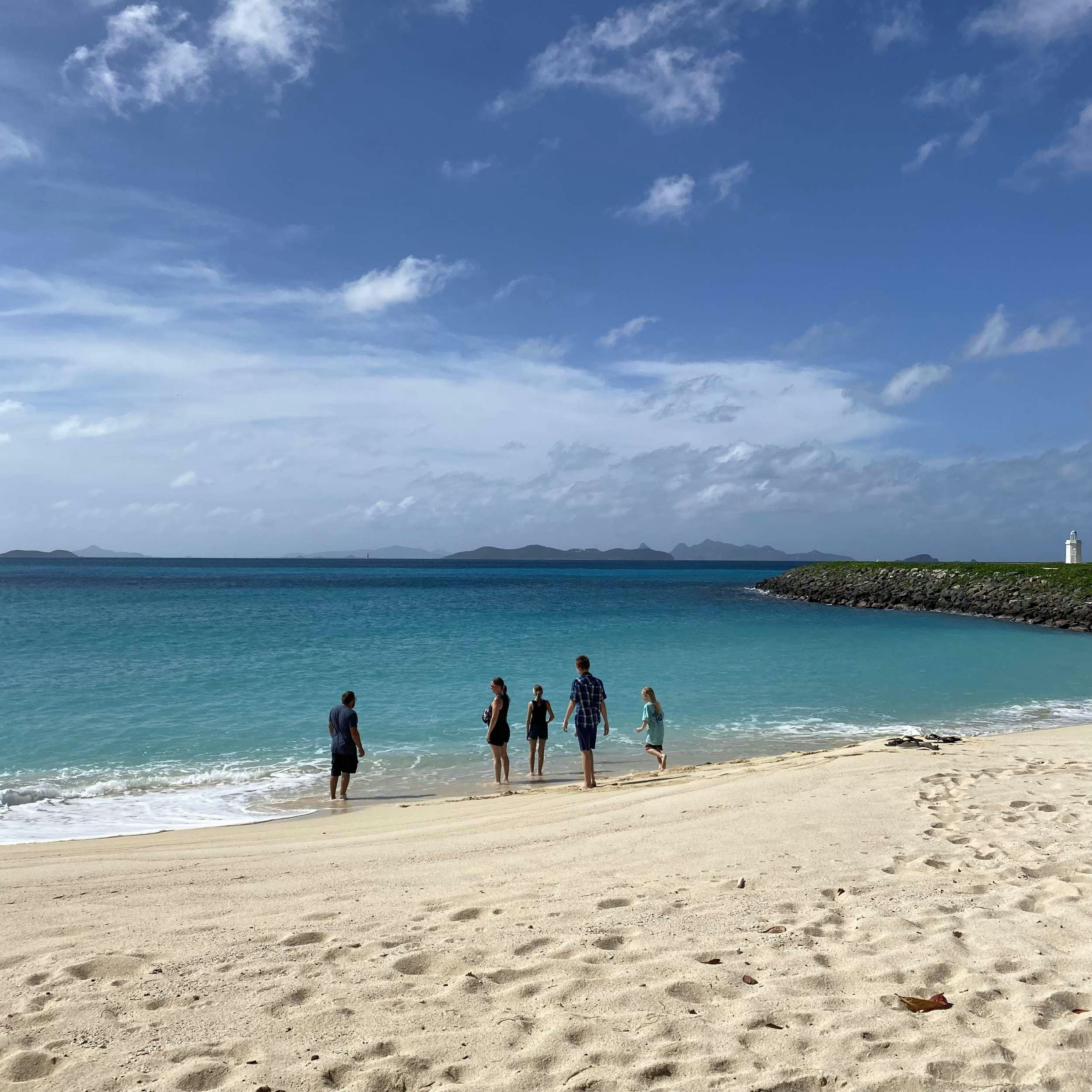 a group of people walking on a beach aboard SOME KIND OF WONDERFUL Yacht for Charter