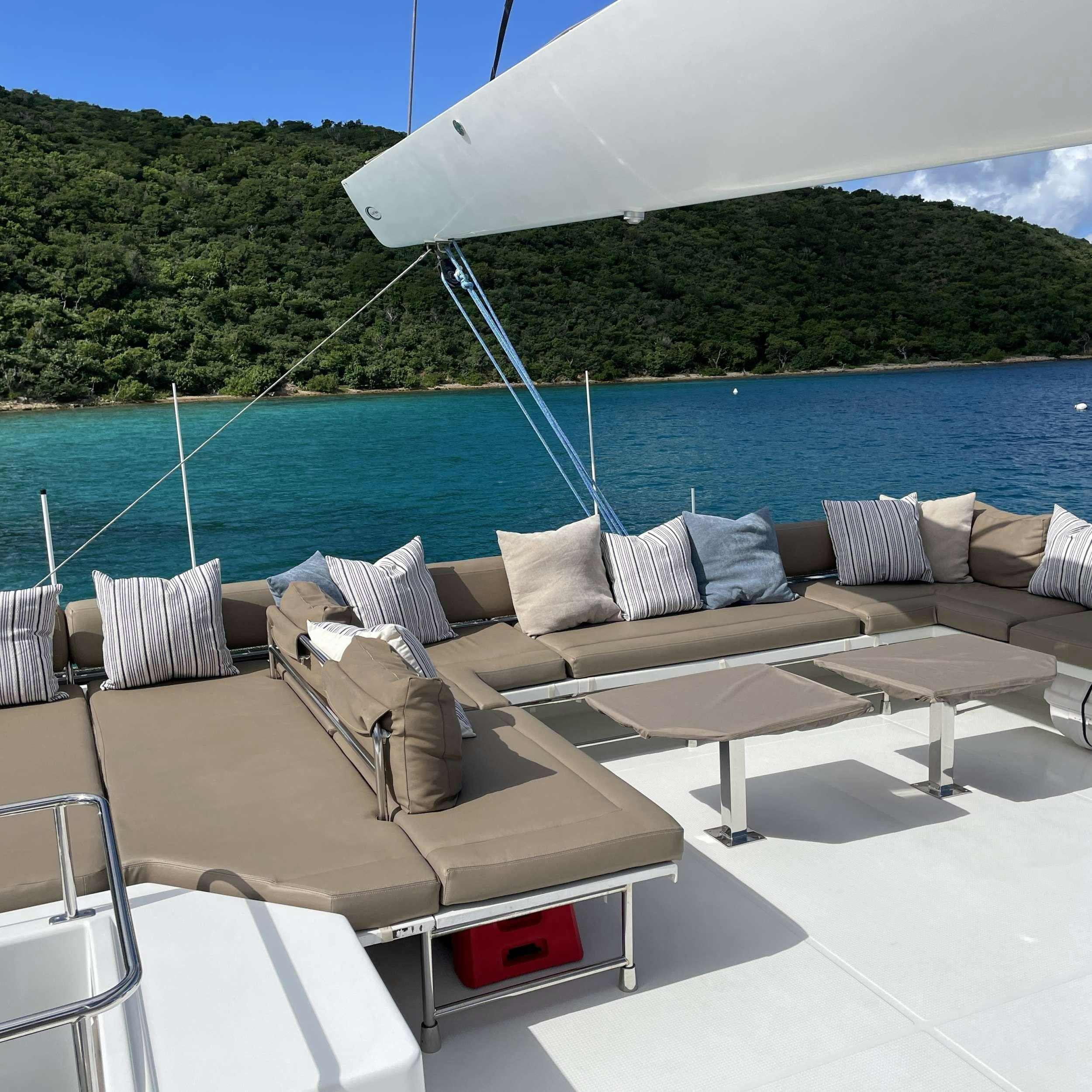 a lounge area with a large umbrella aboard SOME KIND OF WONDERFUL Yacht for Charter