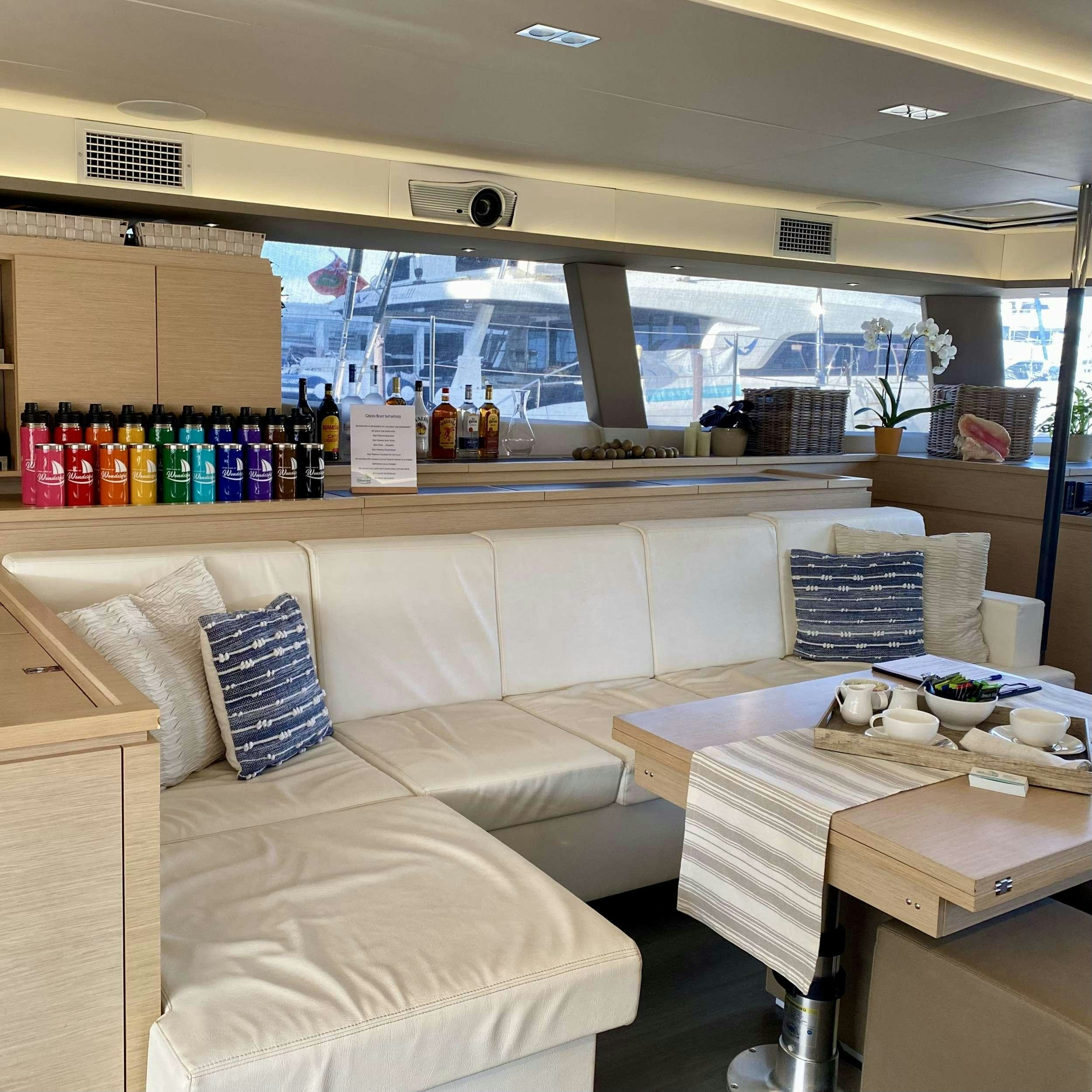 a room with a couch and a table aboard SOME KIND OF WONDERFUL Yacht for Charter