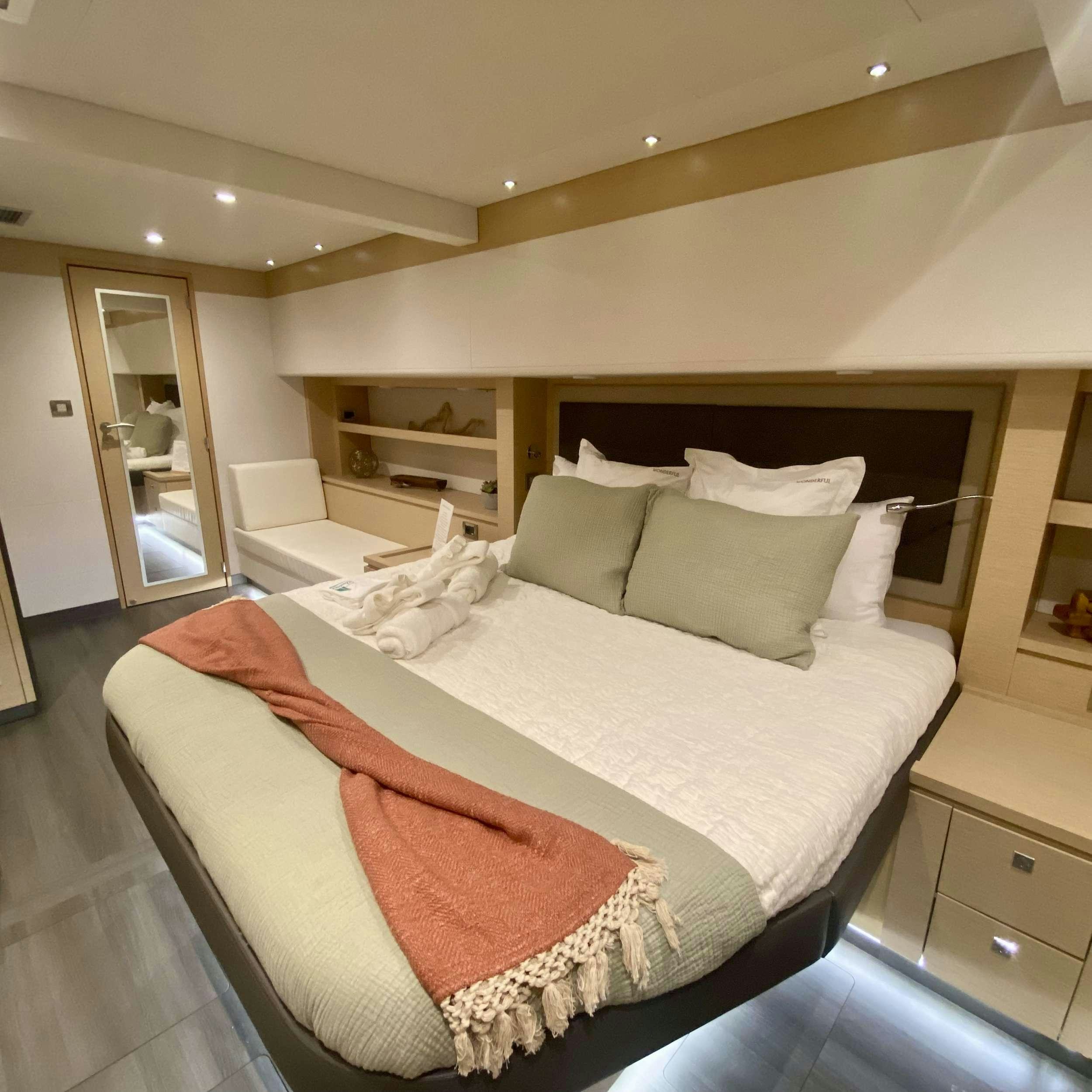 a bed with a red blanket aboard SOME KIND OF WONDERFUL Yacht for Charter