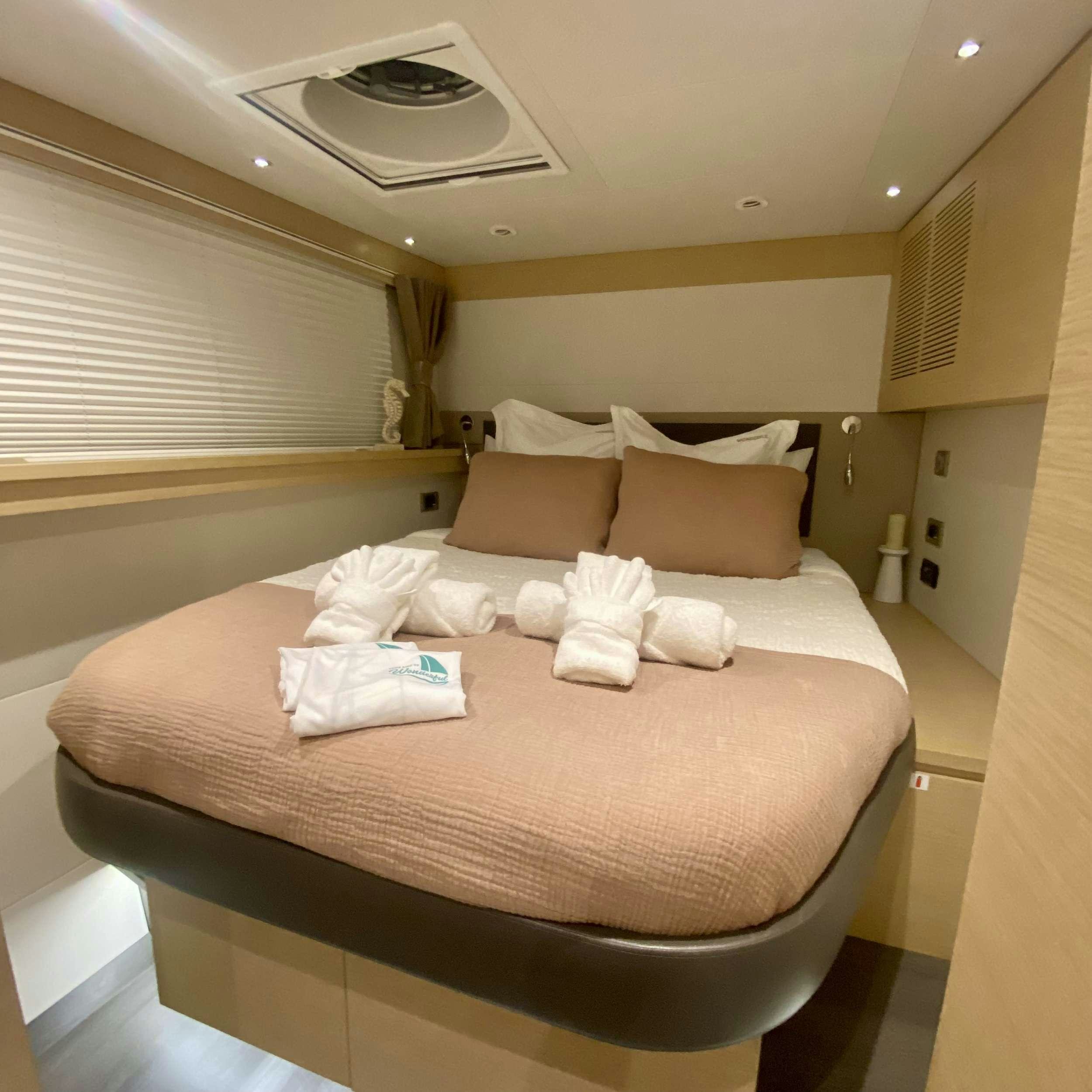 a bed with white pillows aboard SOME KIND OF WONDERFUL Yacht for Charter