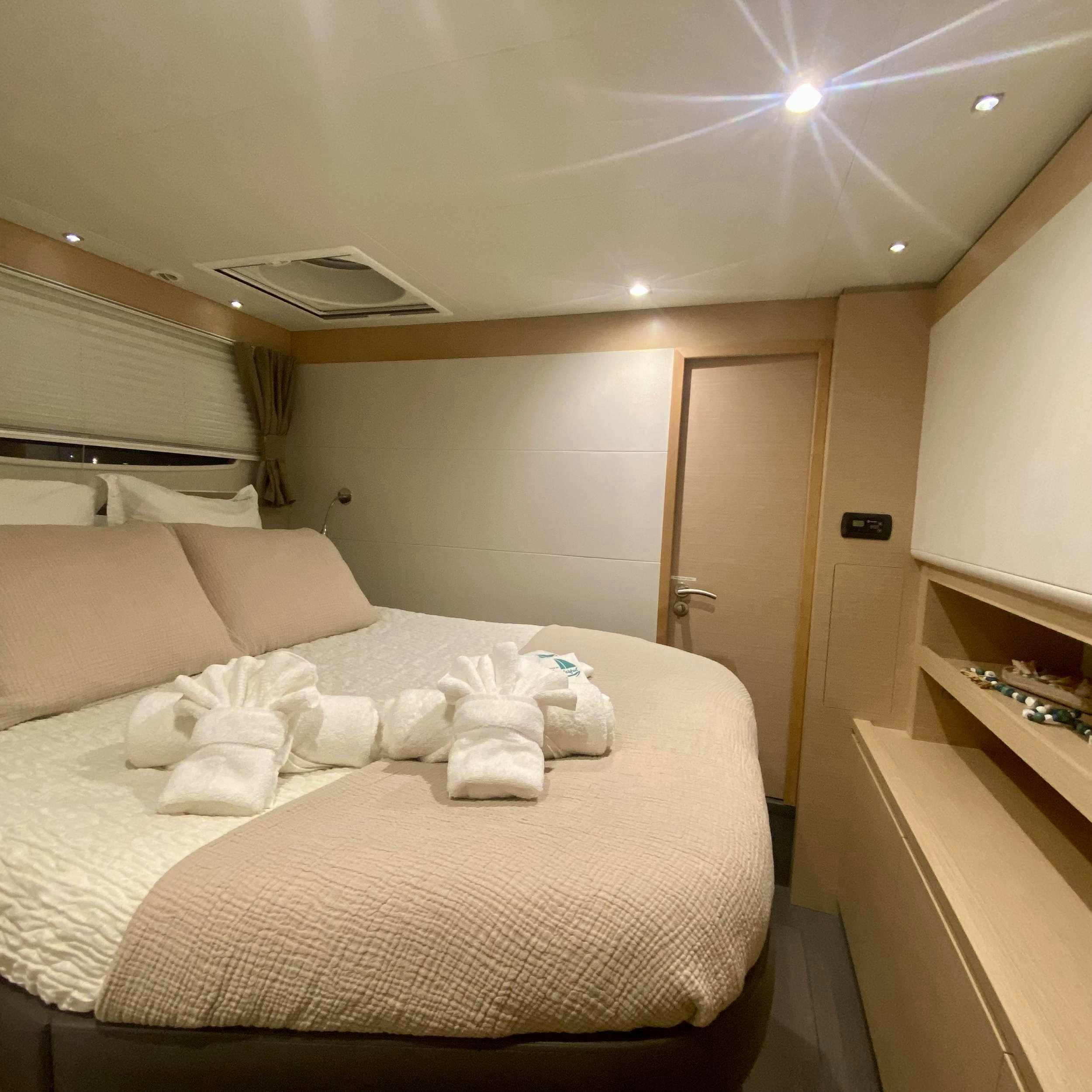a bed with white sheets aboard SOME KIND OF WONDERFUL Yacht for Charter