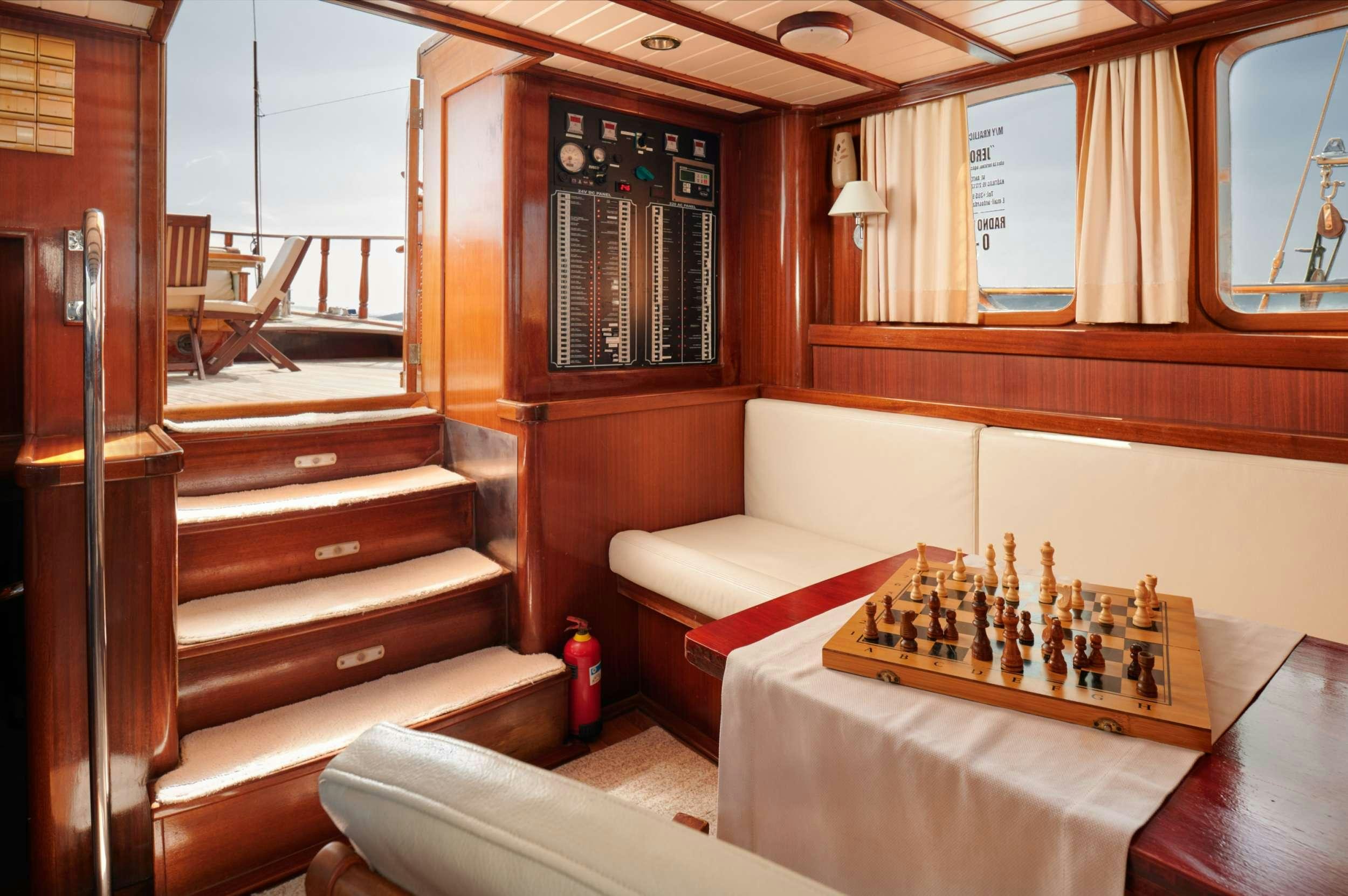 a room with a table and a couch aboard QUEEN OF ADRIATIC Yacht for Charter