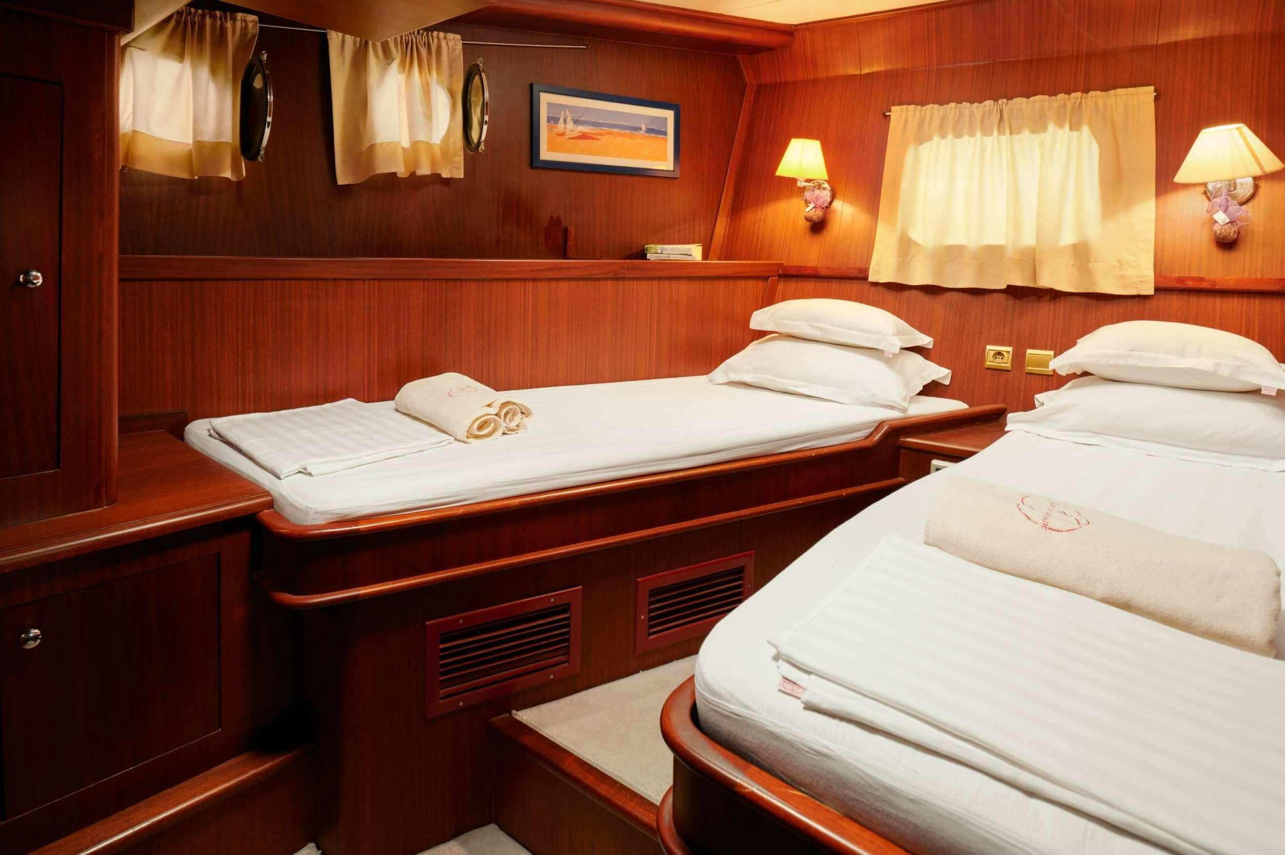 a couple of beds in a hotel room aboard QUEEN OF ADRIATIC Yacht for Charter