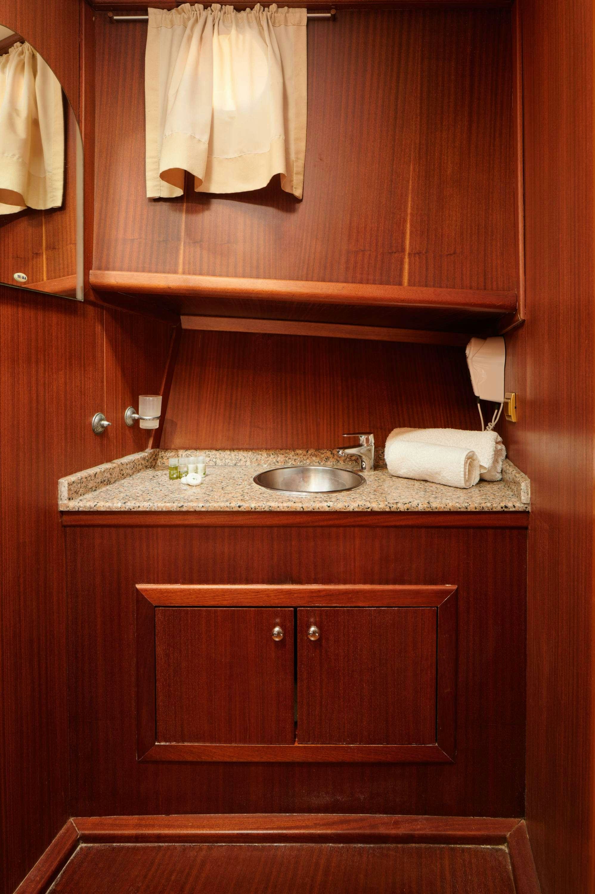 a sink with a mirror above it aboard QUEEN OF ADRIATIC Yacht for Charter
