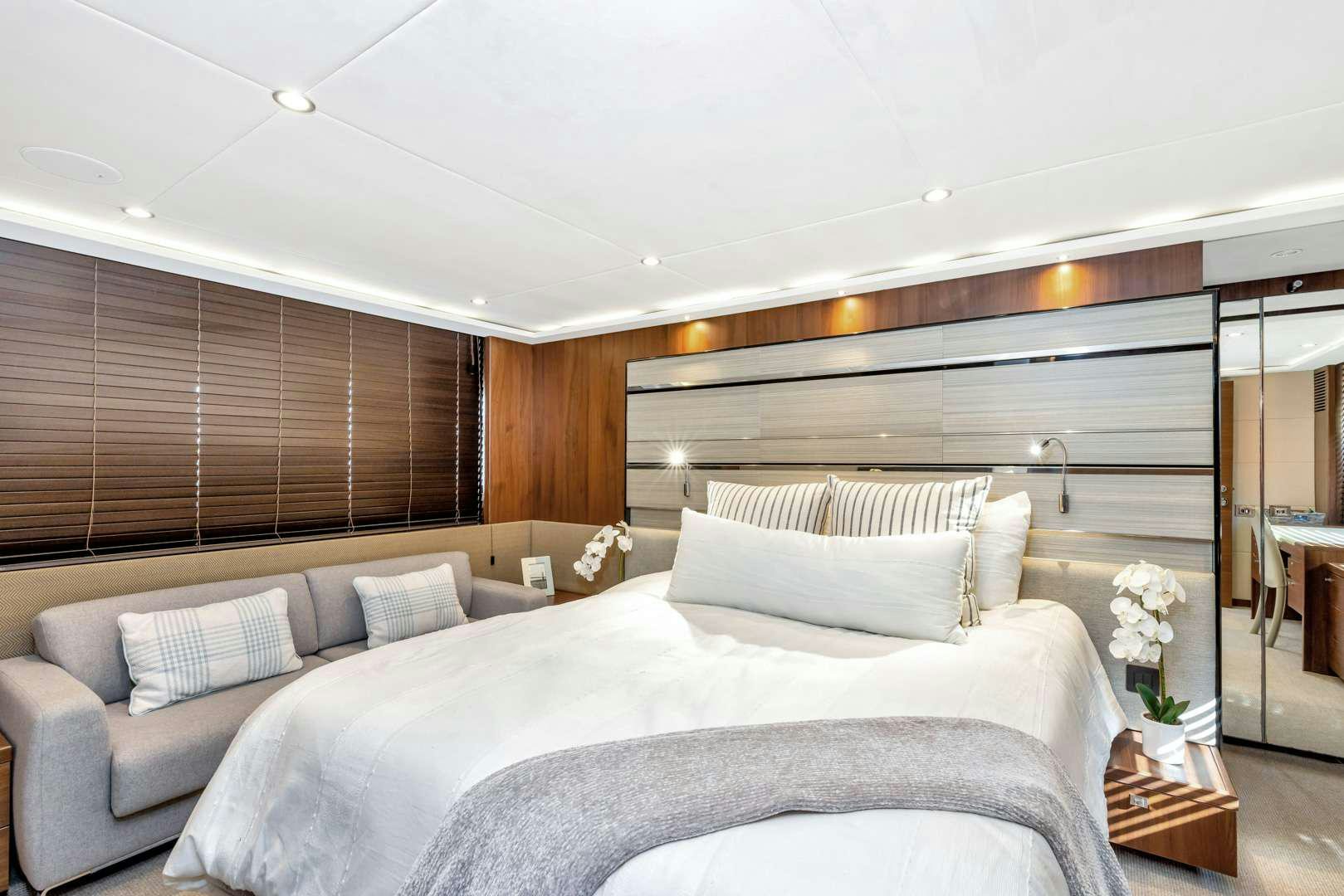 a bedroom with a bed and a couch aboard SNOWBIRD Yacht for Charter