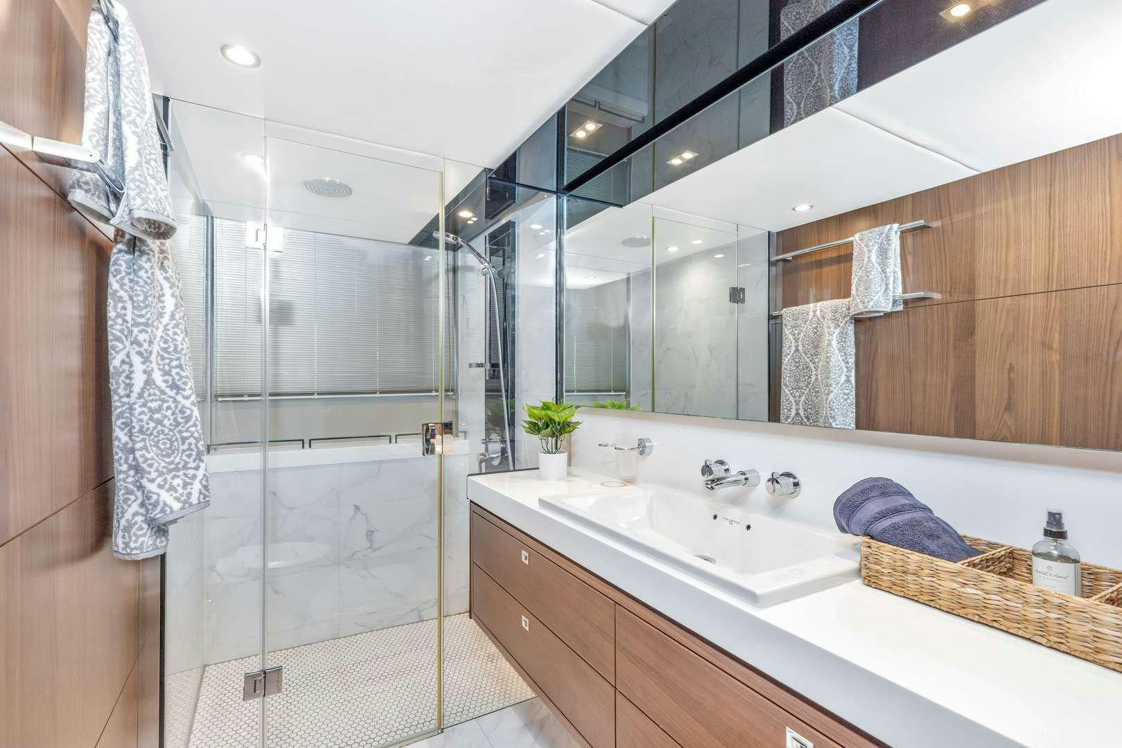 a bathroom with a glass shower aboard SNOWBIRD Yacht for Charter