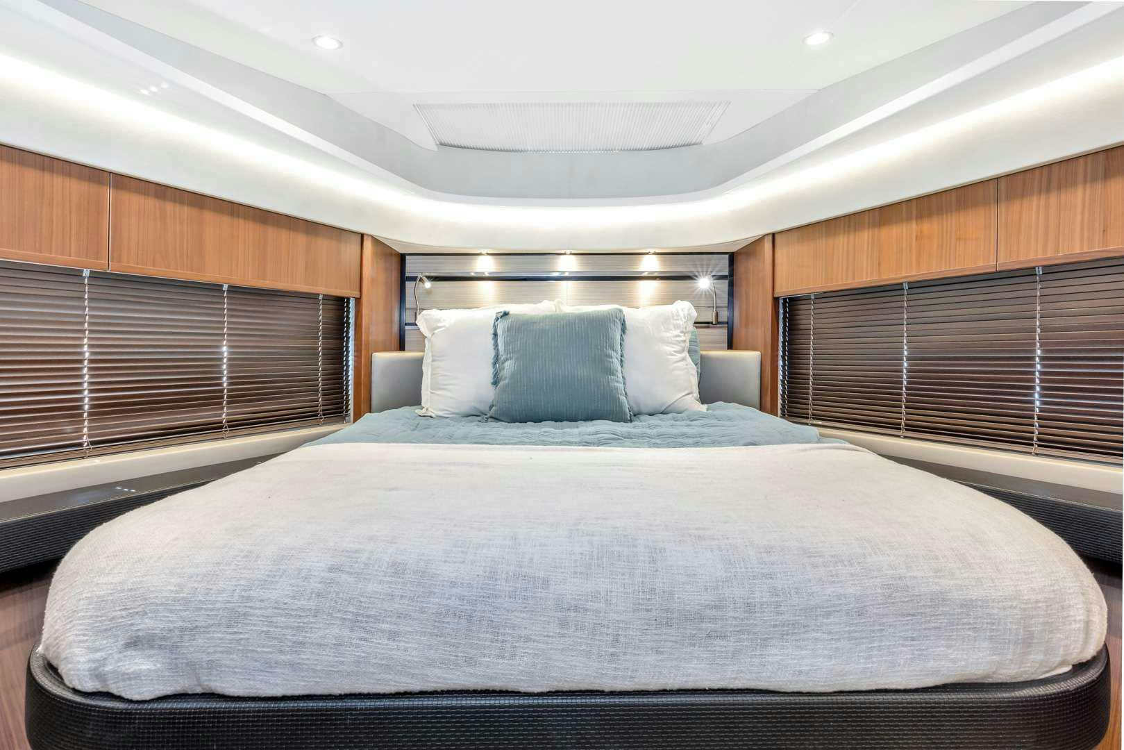 a bed with a white sheet aboard SNOWBIRD Yacht for Charter
