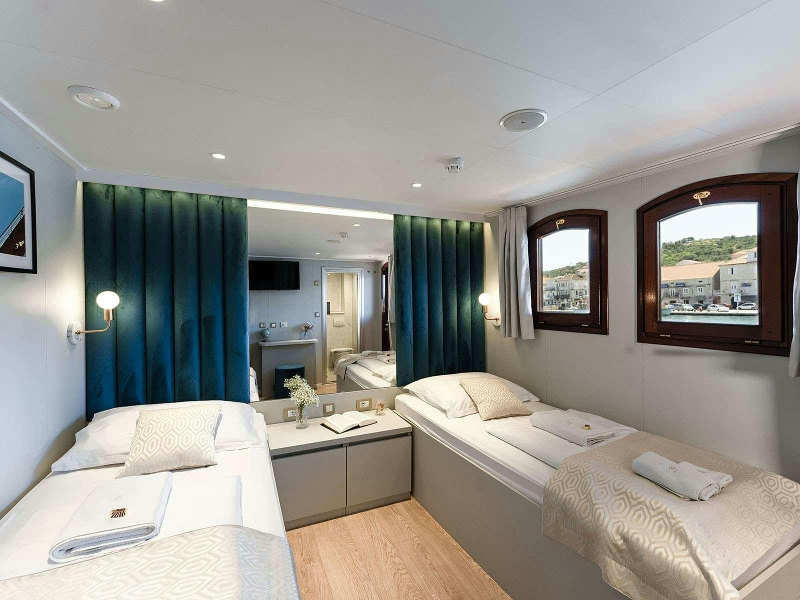 a room with two beds aboard BELLEZZA Yacht for Charter