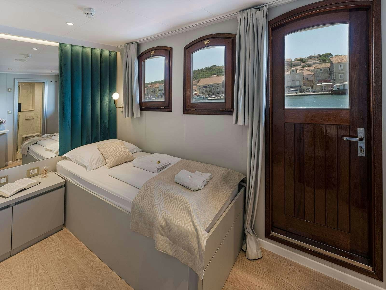 a hotel room with a bed aboard BELLEZZA Yacht for Charter