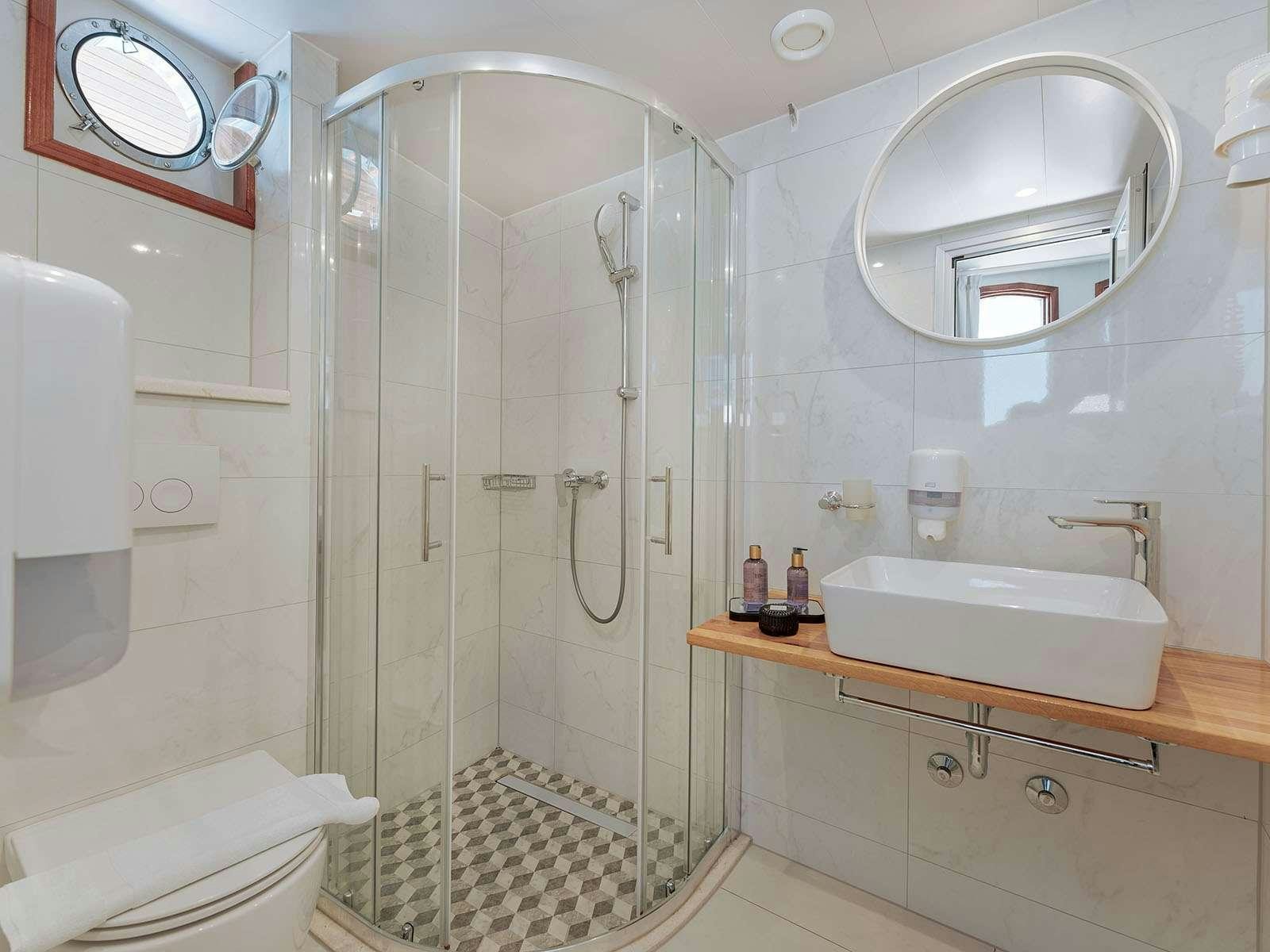 a bathroom with a glass shower aboard BELLEZZA Yacht for Charter