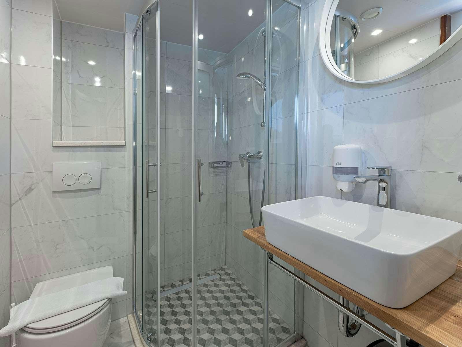 a bathroom with a glass shower aboard BELLEZZA Yacht for Charter