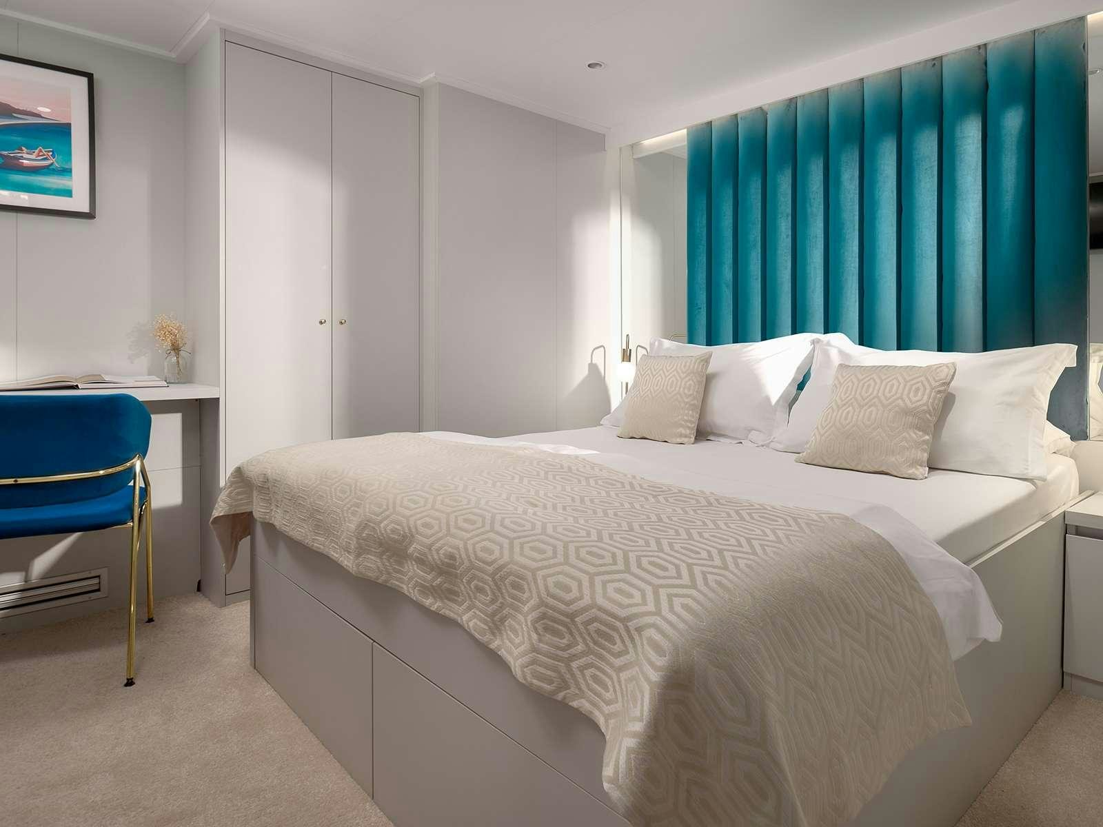 a bed with white sheets aboard BELLEZZA Yacht for Charter