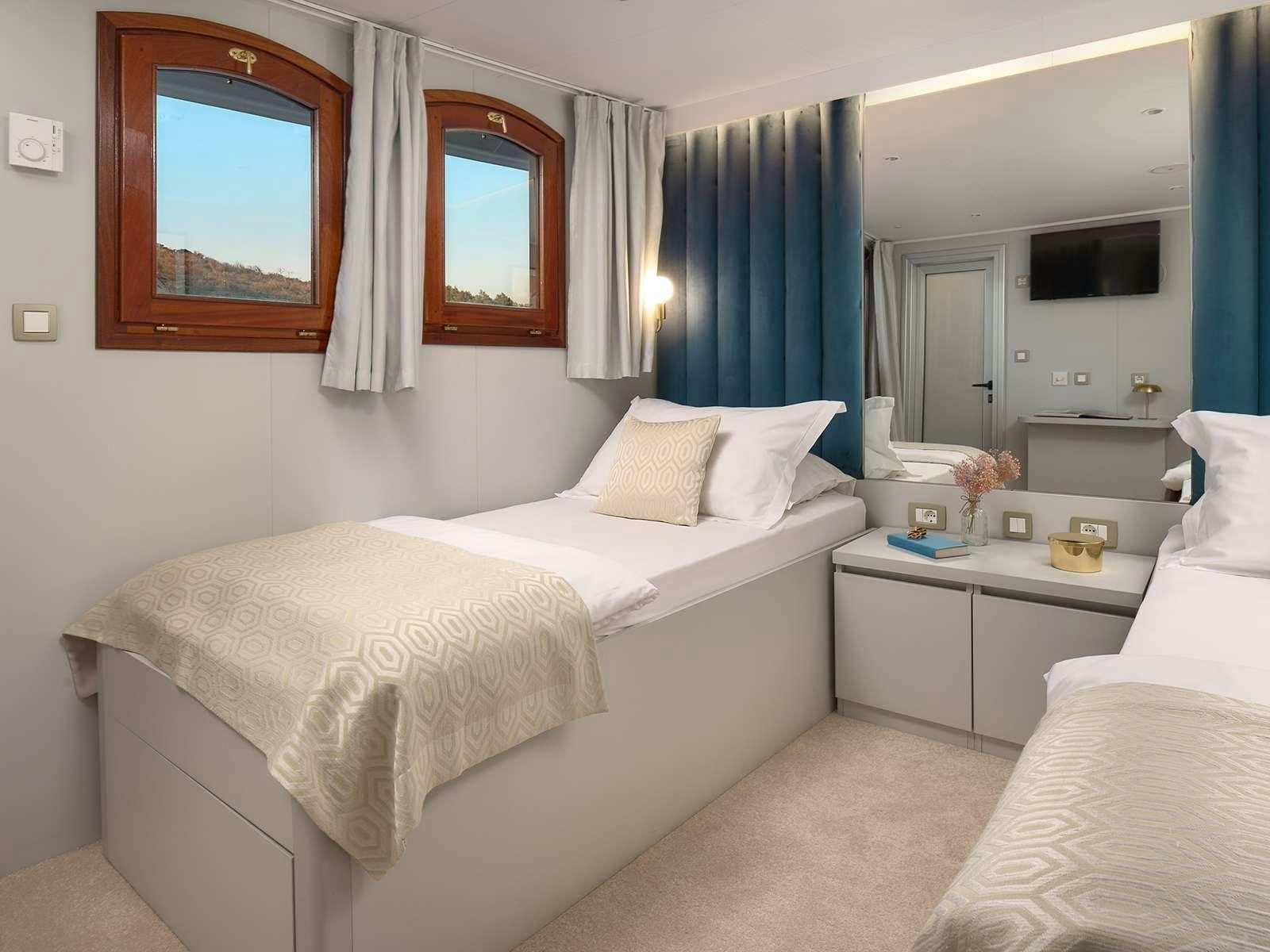 a room with two beds aboard BELLEZZA Yacht for Charter
