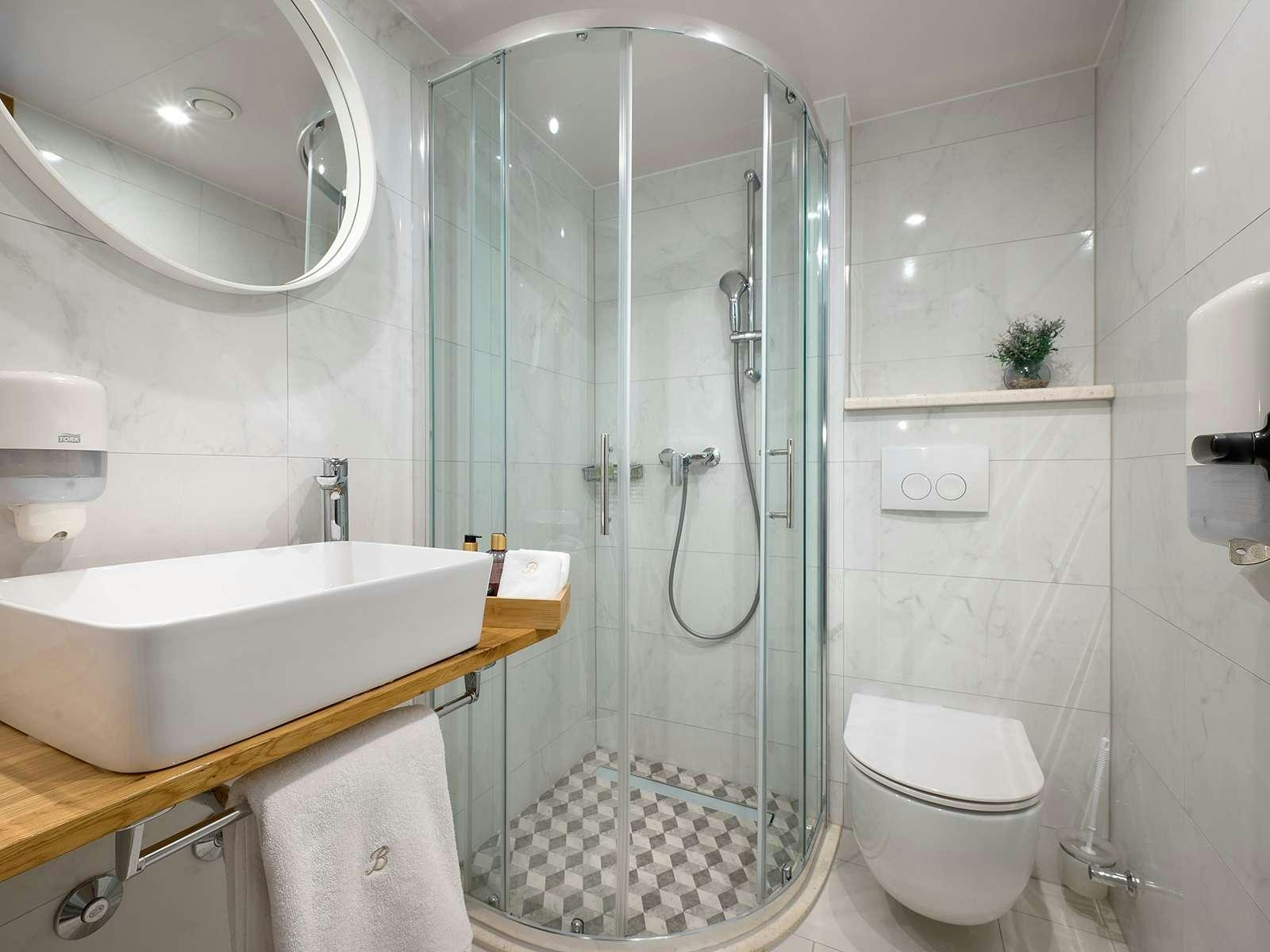 a bathroom with a glass shower aboard BELLEZZA Yacht for Charter