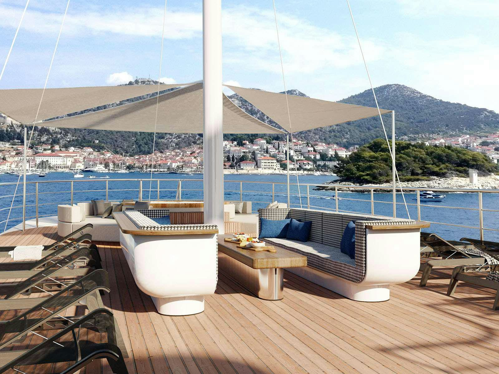 a large white bathtub on a deck overlooking a large body of water aboard BELLEZZA Yacht for Charter