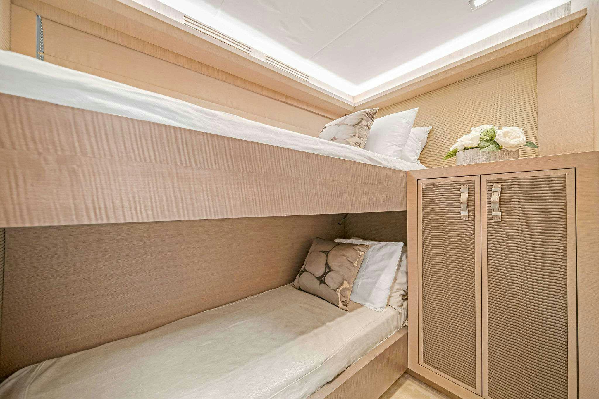 a bed with white sheets aboard VOLO Yacht for Charter