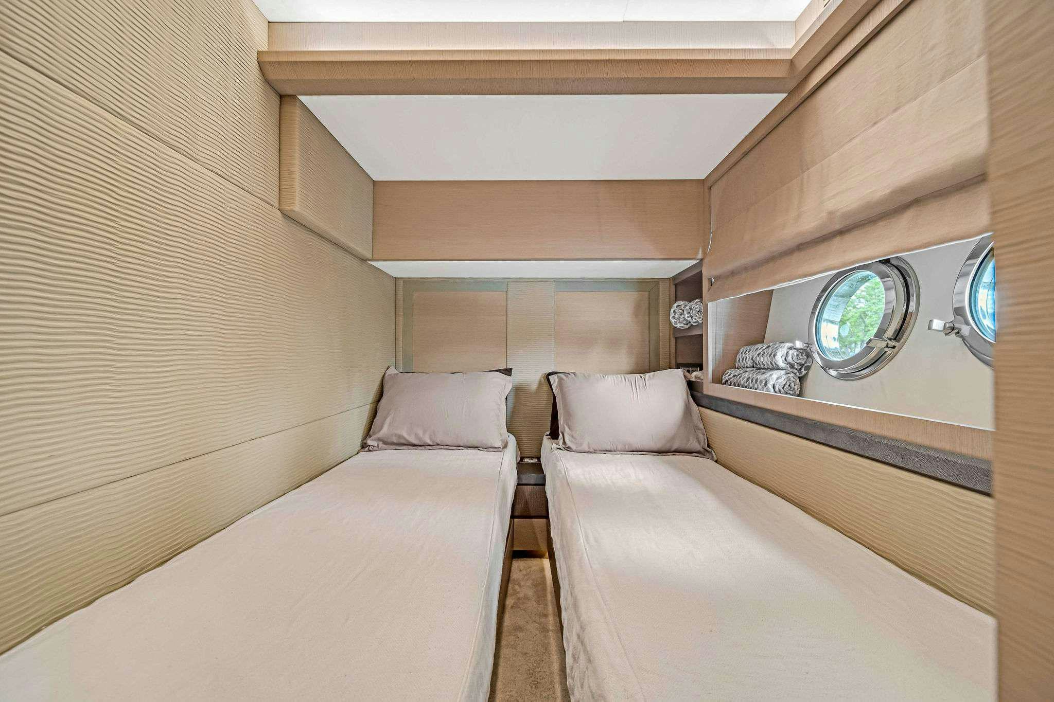 a room with two beds aboard VOLO Yacht for Charter