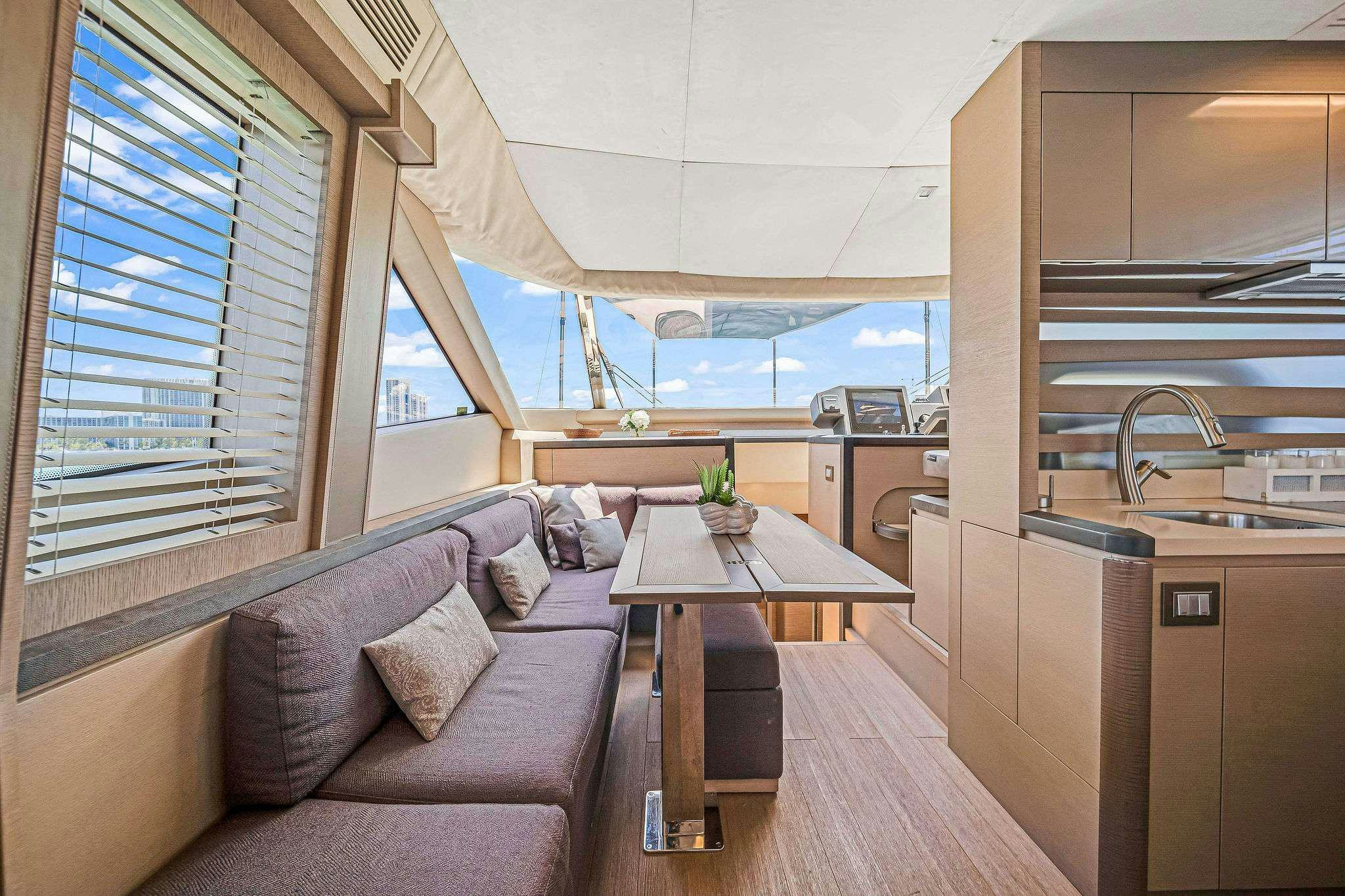 a living room with a couch and a table aboard VOLO Yacht for Charter