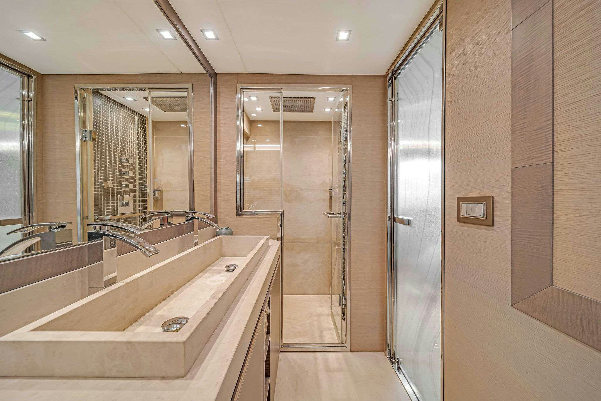 a bathroom with a large mirror aboard VOLO Yacht for Charter