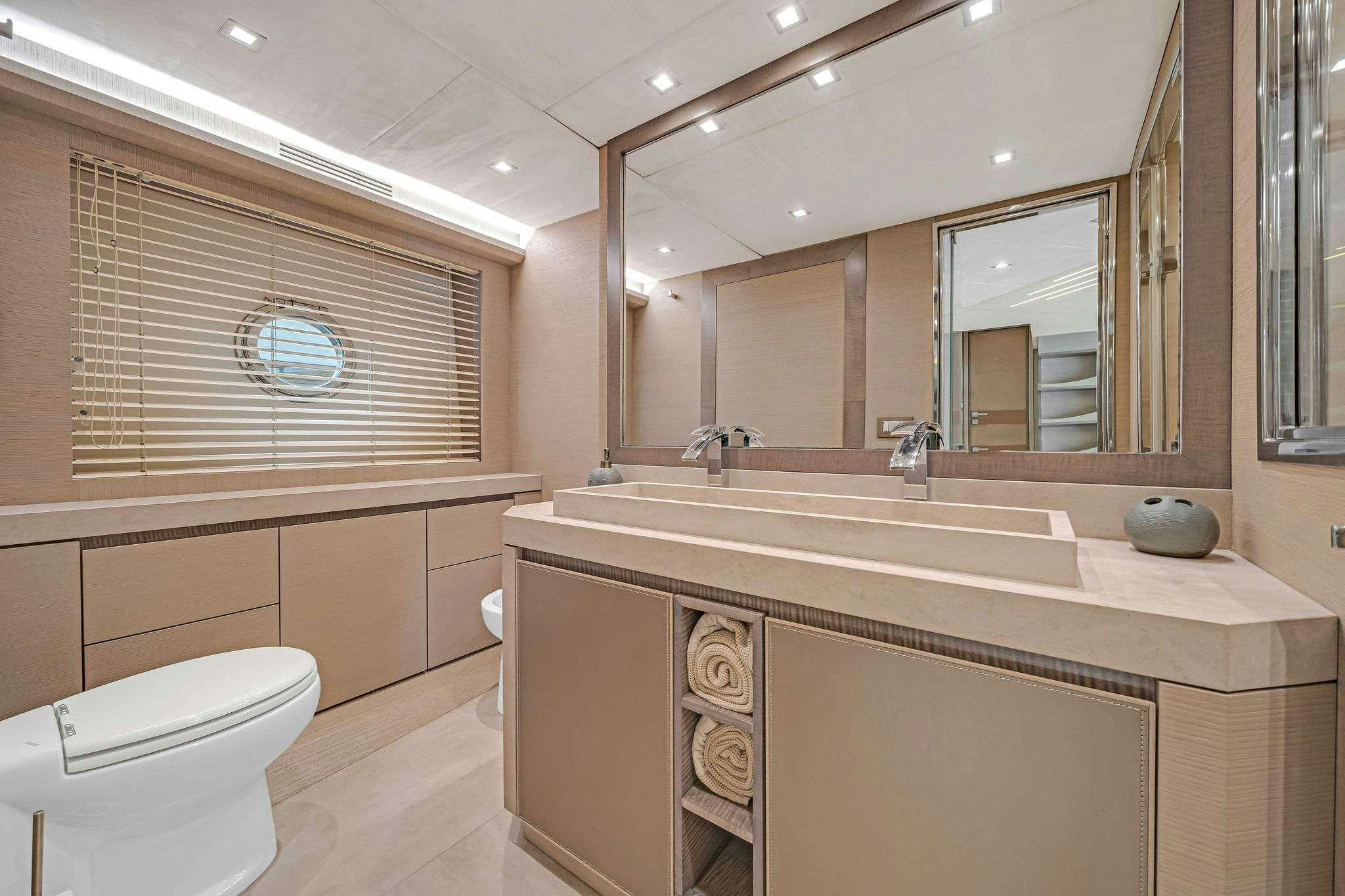 a bathroom with a large mirror aboard VOLO Yacht for Charter