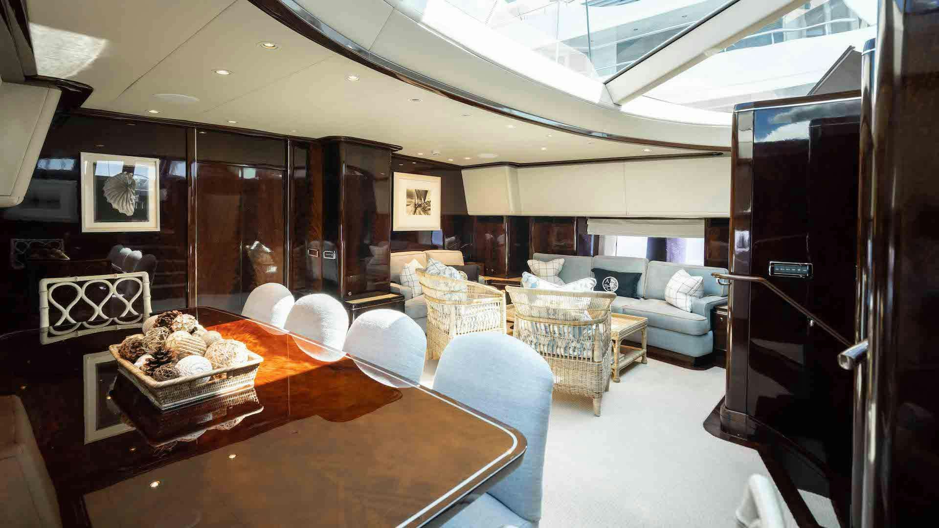 a room with a table chairs and a couch aboard ANEMOI Yacht for Charter