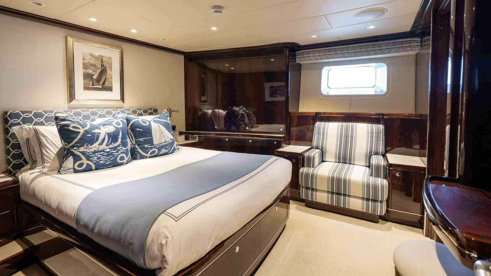 a bedroom with a bed and a couch aboard ANEMOI Yacht for Charter