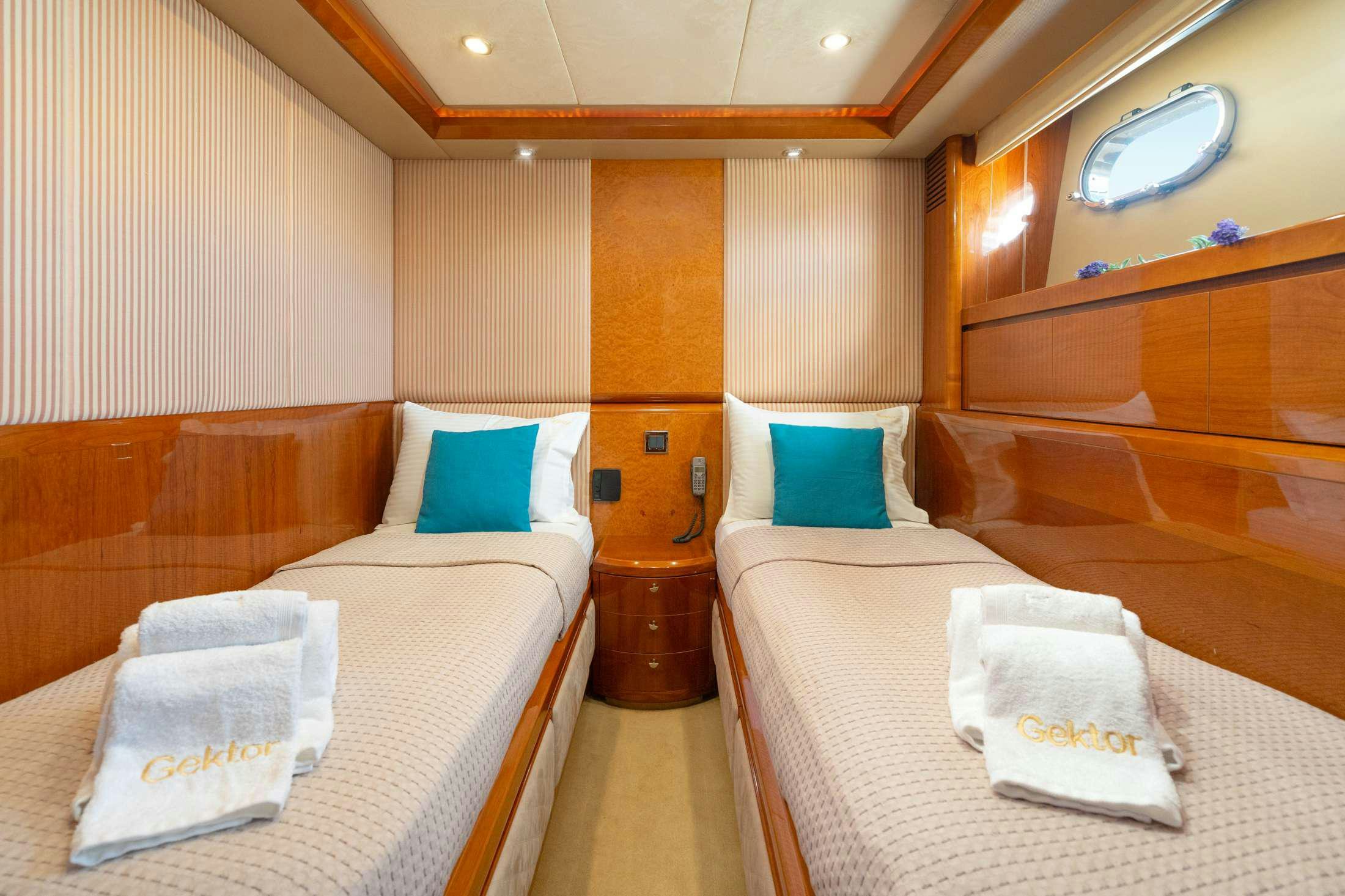 a room with beds and a mirror aboard GEKTOR Yacht for Charter