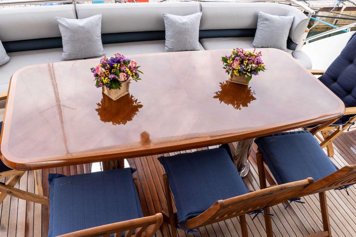 a table with a vase of flowers on it aboard GEKTOR Yacht for Charter