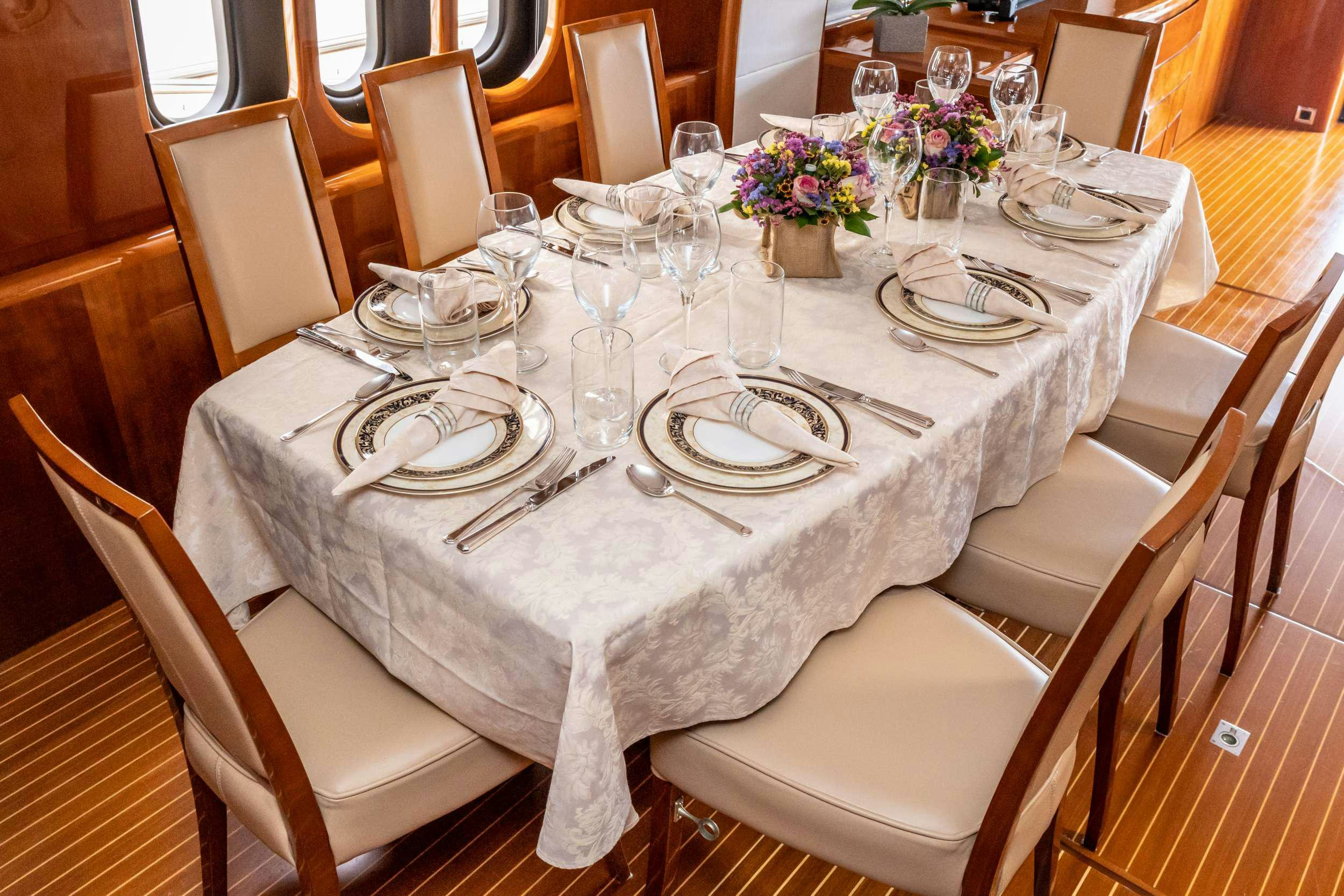 a table set for a dinner aboard GEKTOR Yacht for Charter