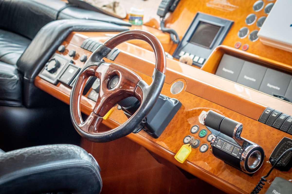 a gun and a gun on a leather couch aboard GEKTOR Yacht for Charter