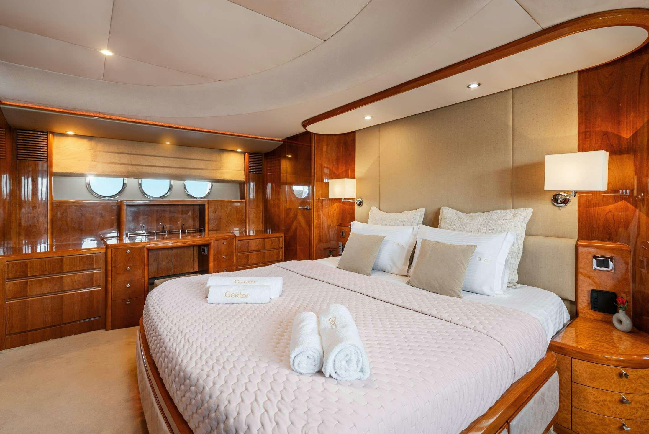 a large bed with white sheets aboard GEKTOR Yacht for Charter