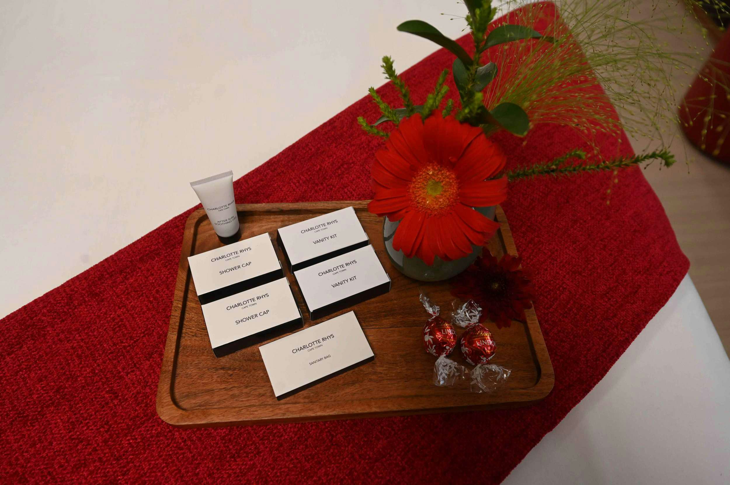a red table with a red table cloth with a red flower and a red flower and a white aboard SKYE Yacht for Charter