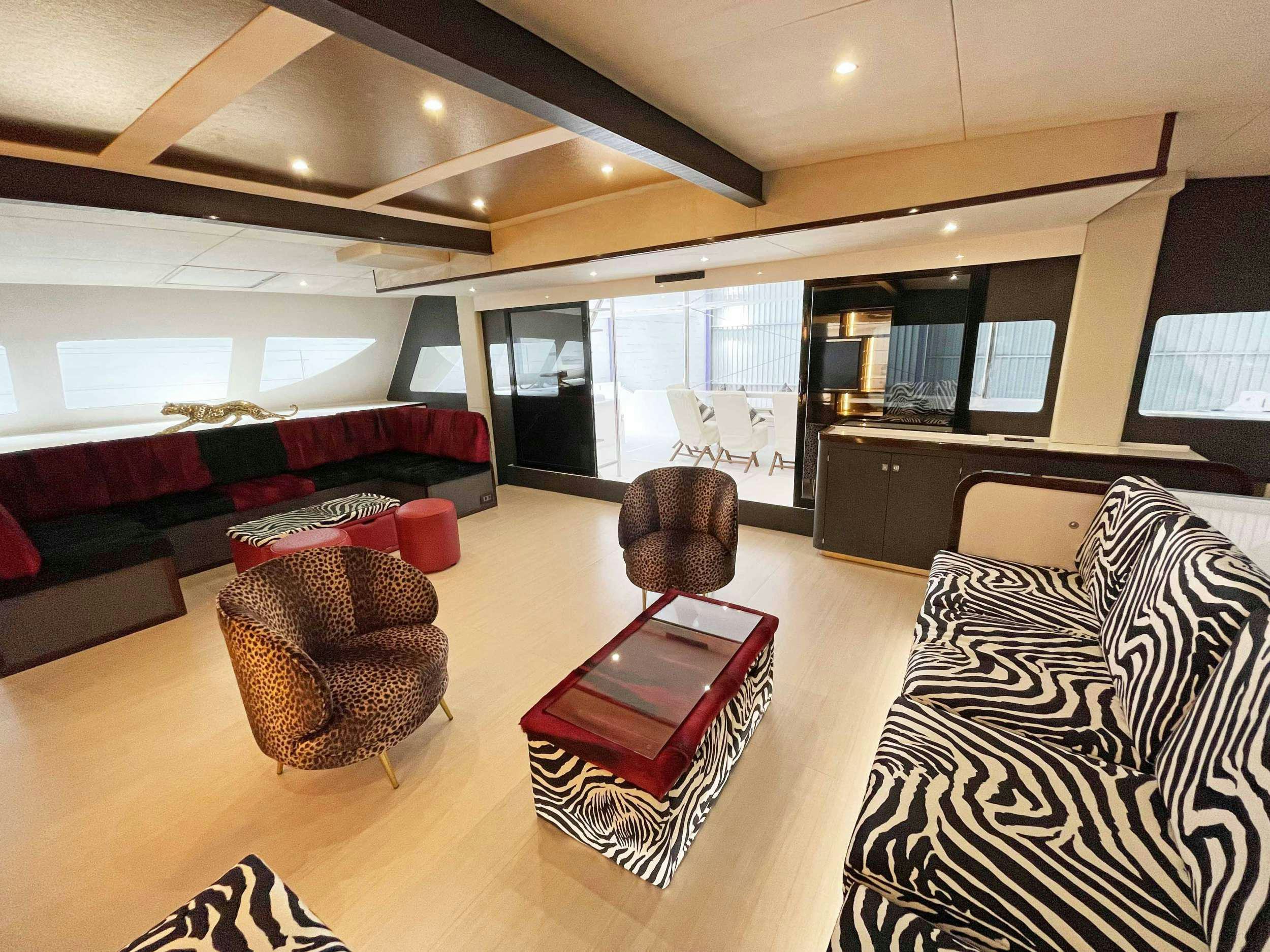 a living room with leather furniture aboard SKYE Yacht for Charter