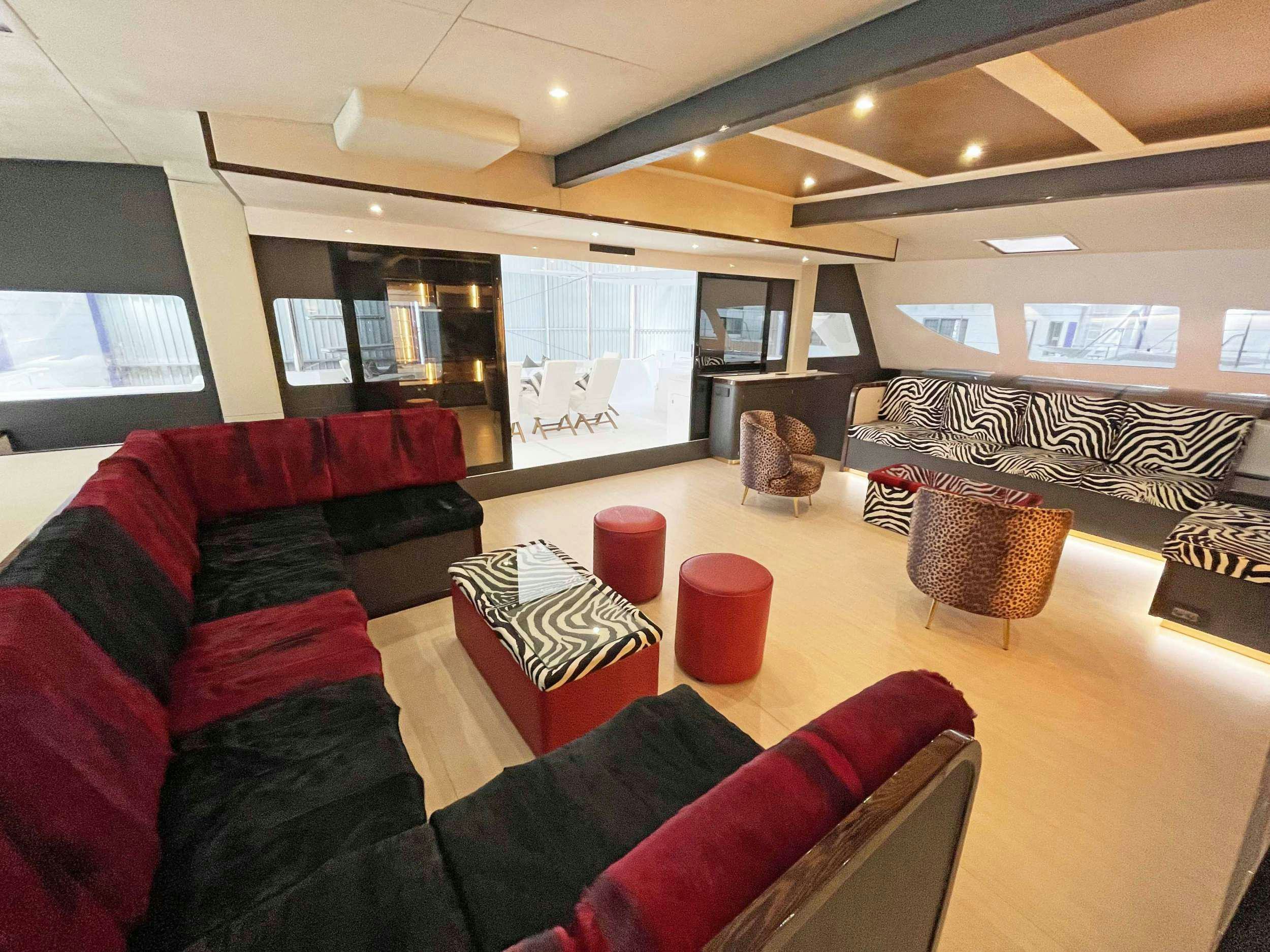 a living room with red couches aboard SKYE Yacht for Charter