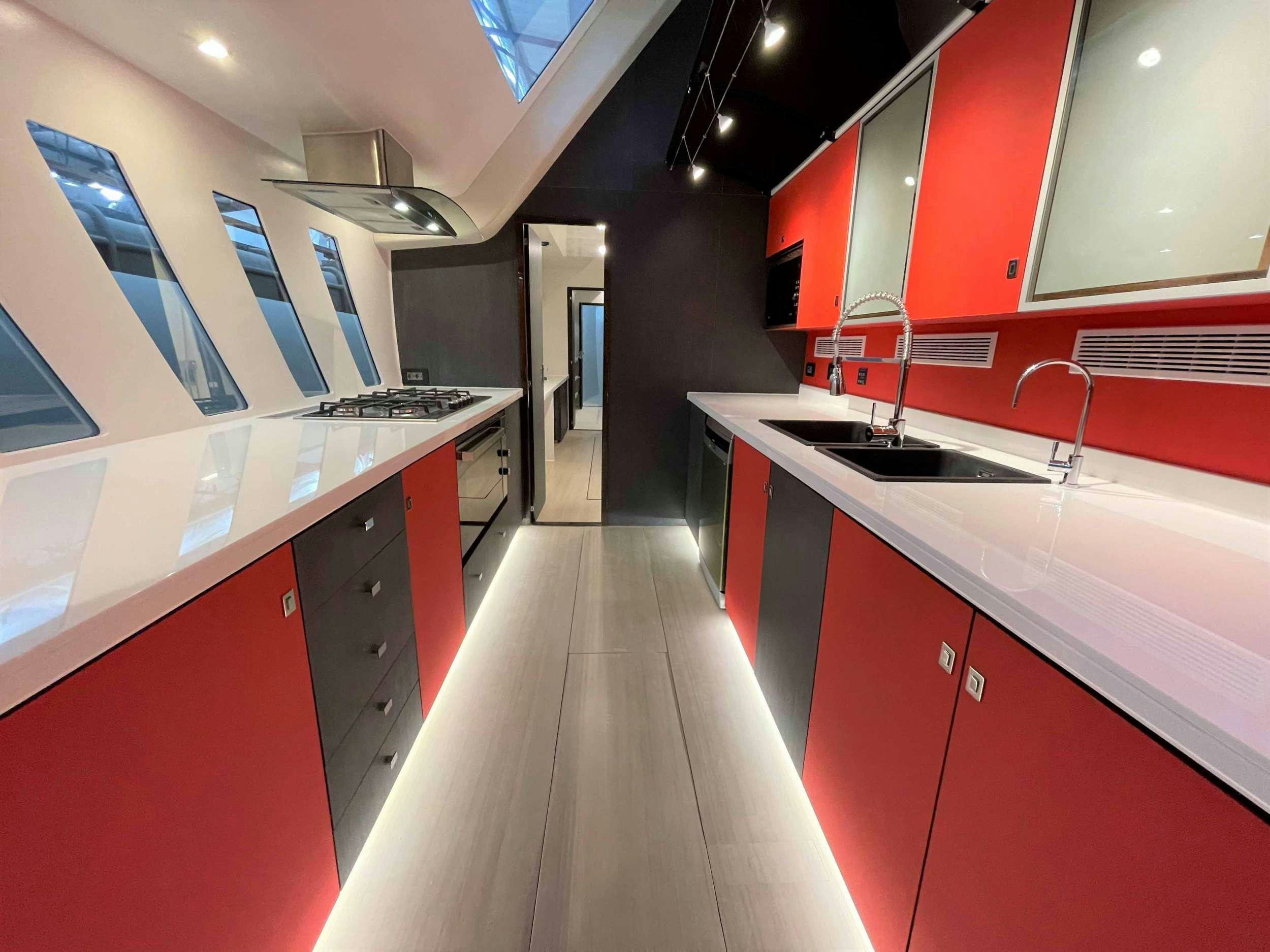 a kitchen with red cabinets aboard SKYE Yacht for Charter