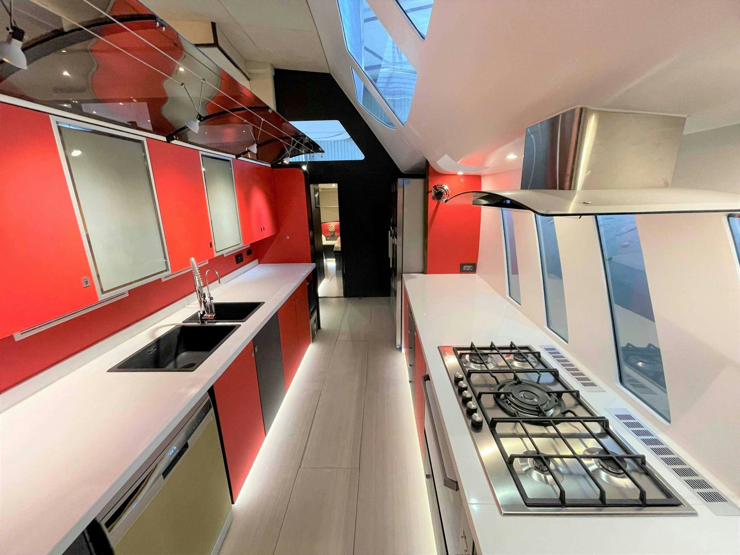 a kitchen with red and white cabinets aboard SKYE Yacht for Charter