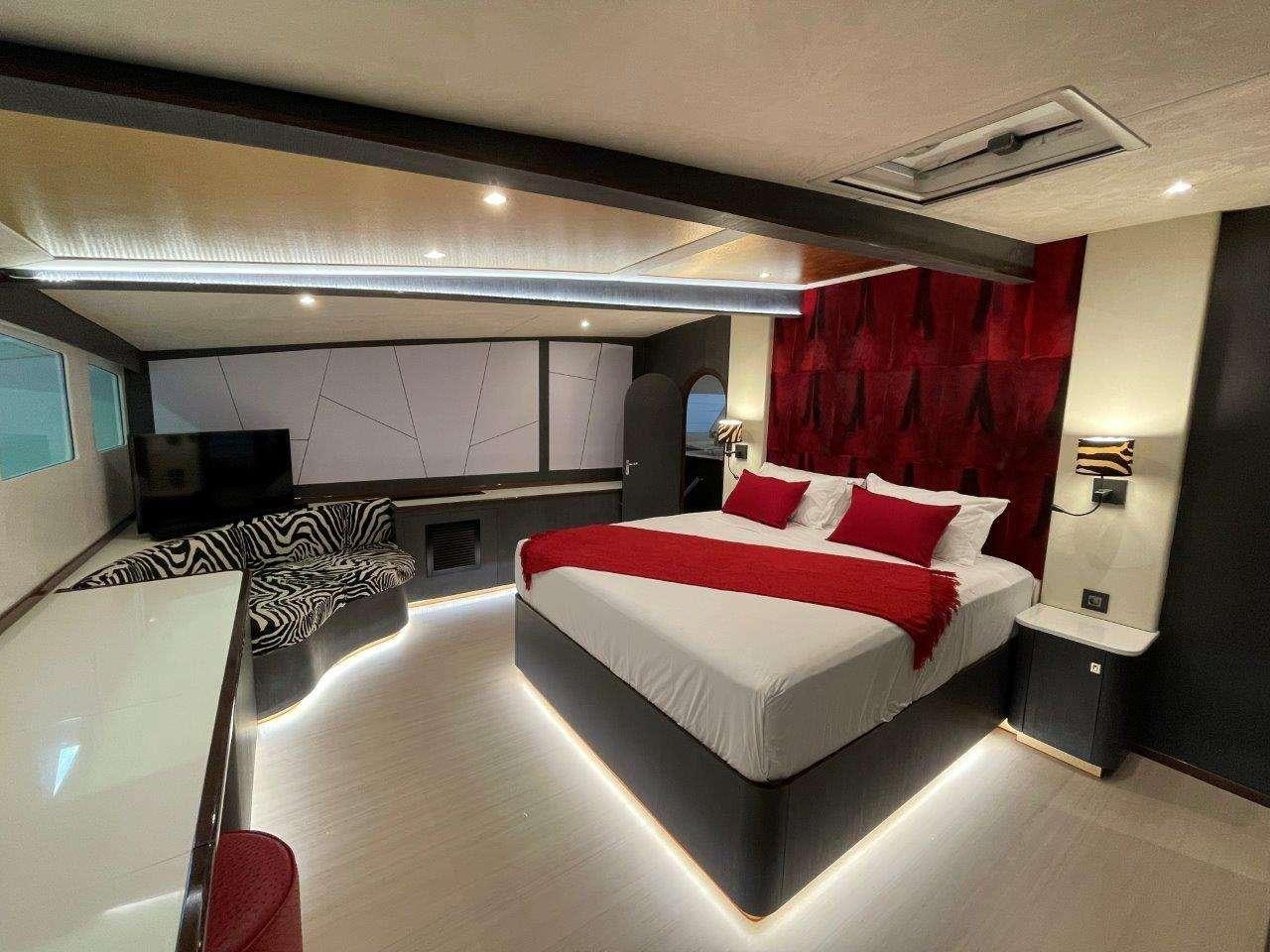 a room with a bed and a desk aboard SKYE Yacht for Charter