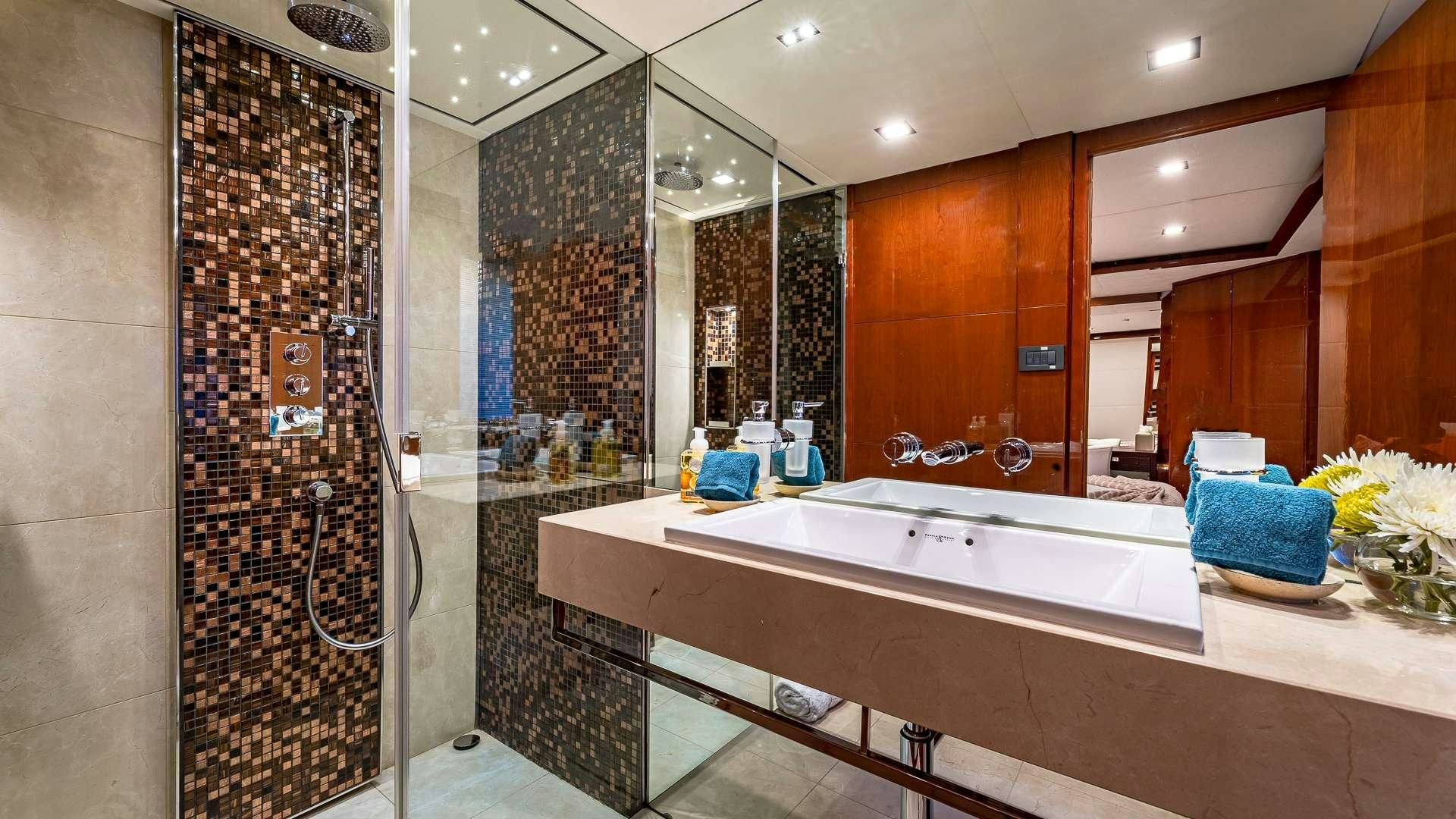 a bathroom with a bathtub and shower aboard BEACHFRONT II Yacht for Charter
