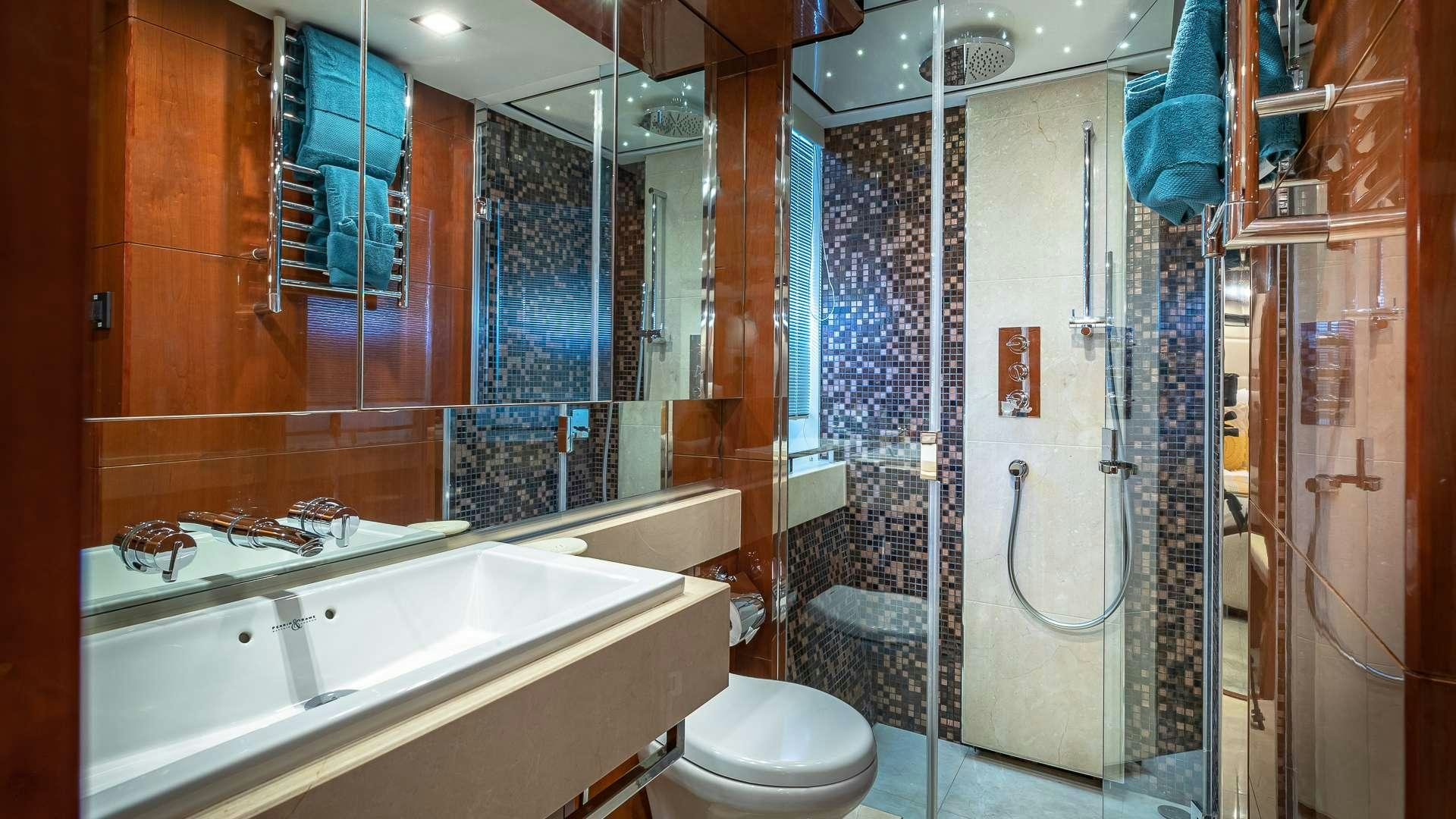 a bathroom with a glass shower aboard BEACHFRONT II Yacht for Charter