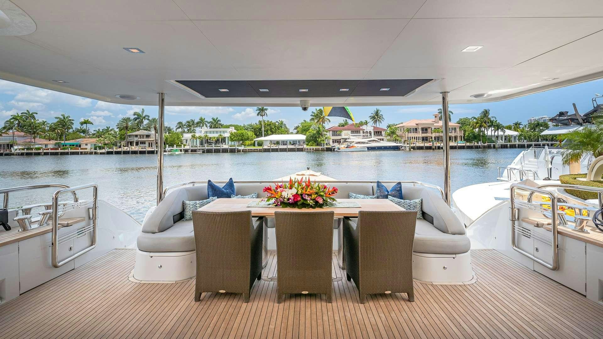 a table and chairs on a deck aboard BEACHFRONT II Yacht for Charter