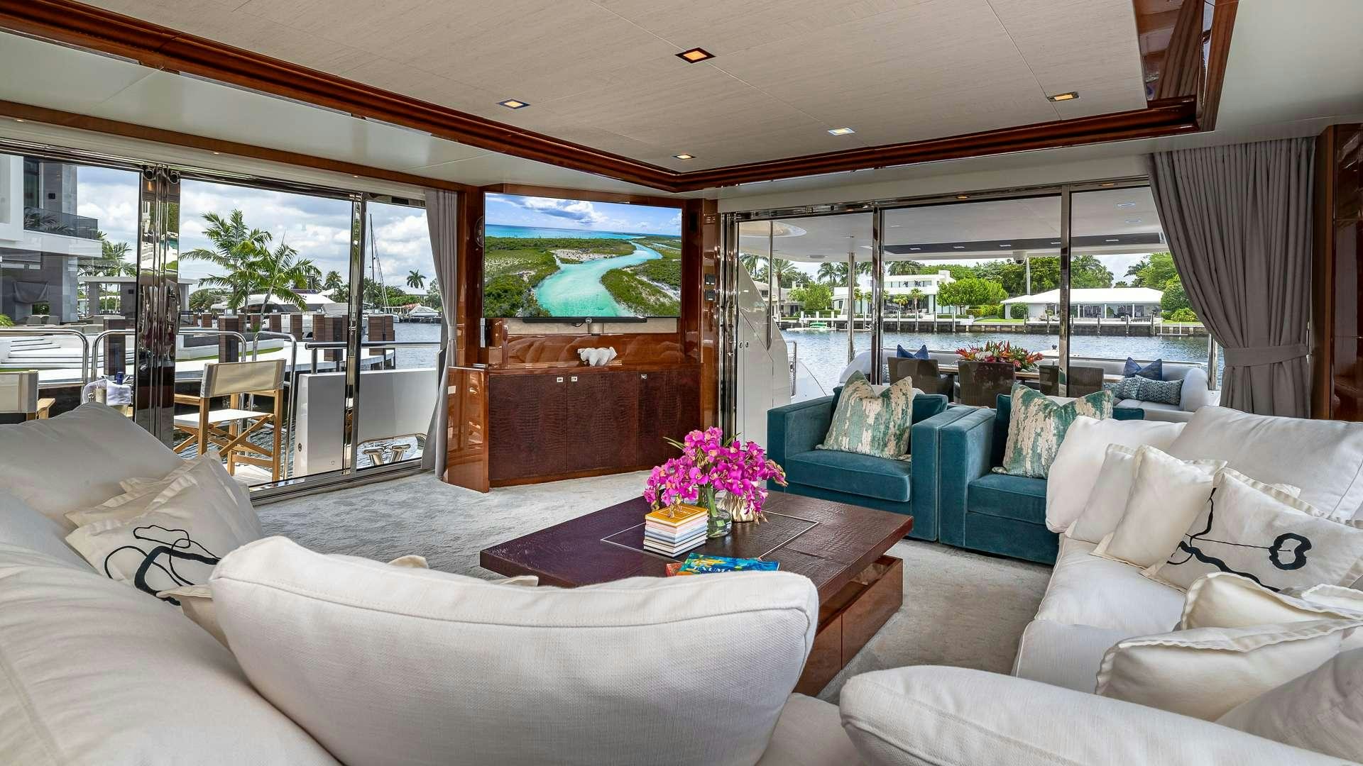 a living room with a large glass window aboard BEACHFRONT II Yacht for Charter