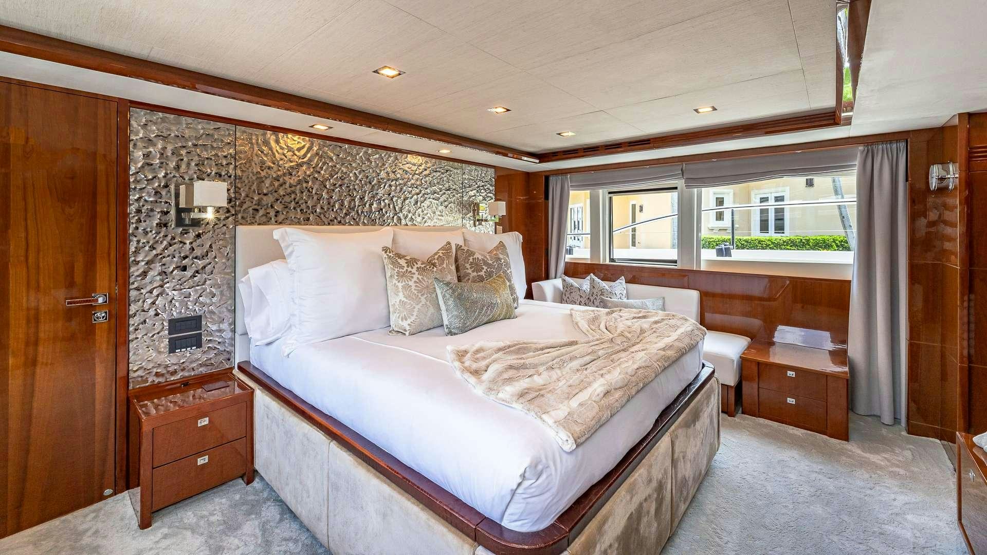 a bedroom with a bed and a desk aboard BEACHFRONT II Yacht for Charter