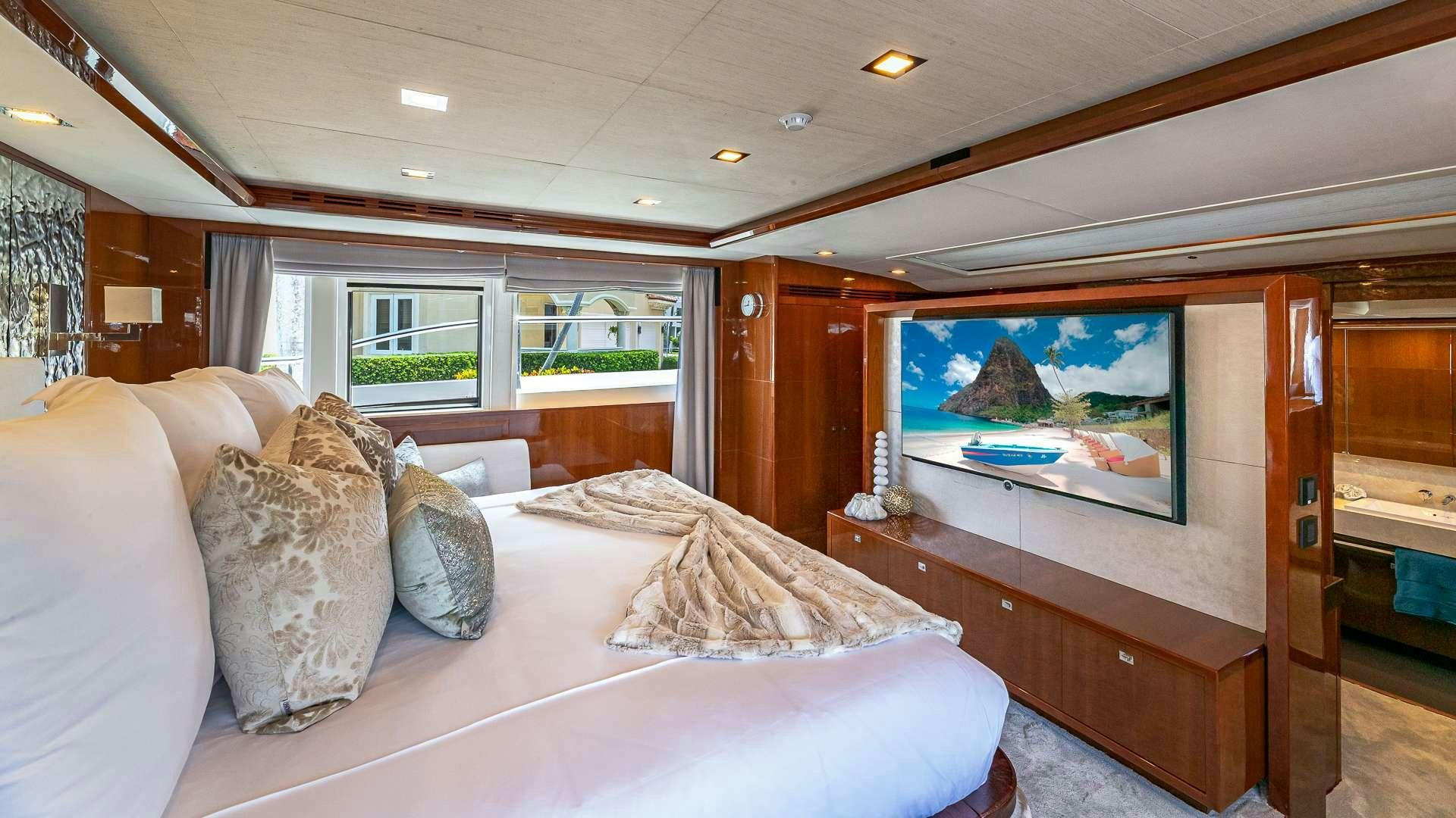 a bedroom with a large bed aboard BEACHFRONT II Yacht for Charter