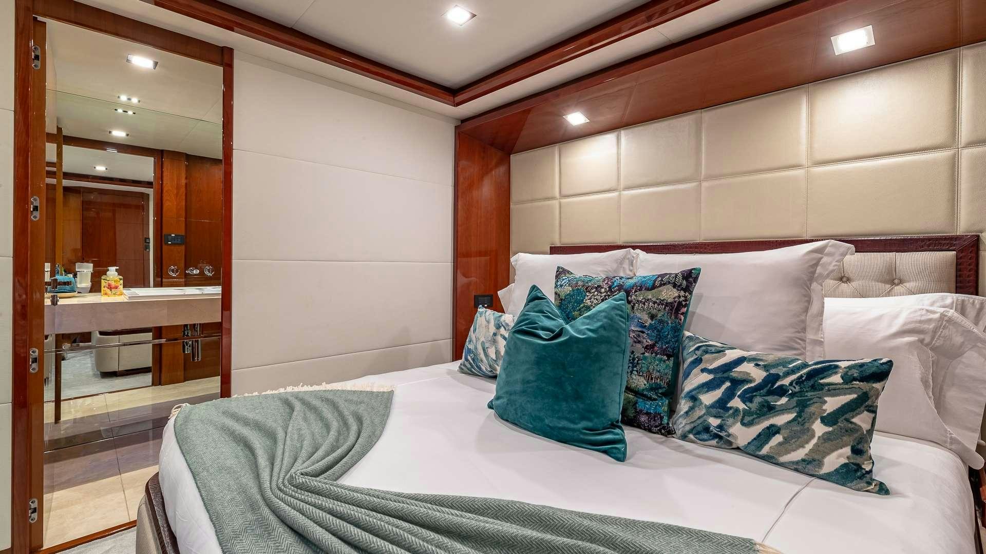 a bed with pillows on it aboard BEACHFRONT II Yacht for Charter