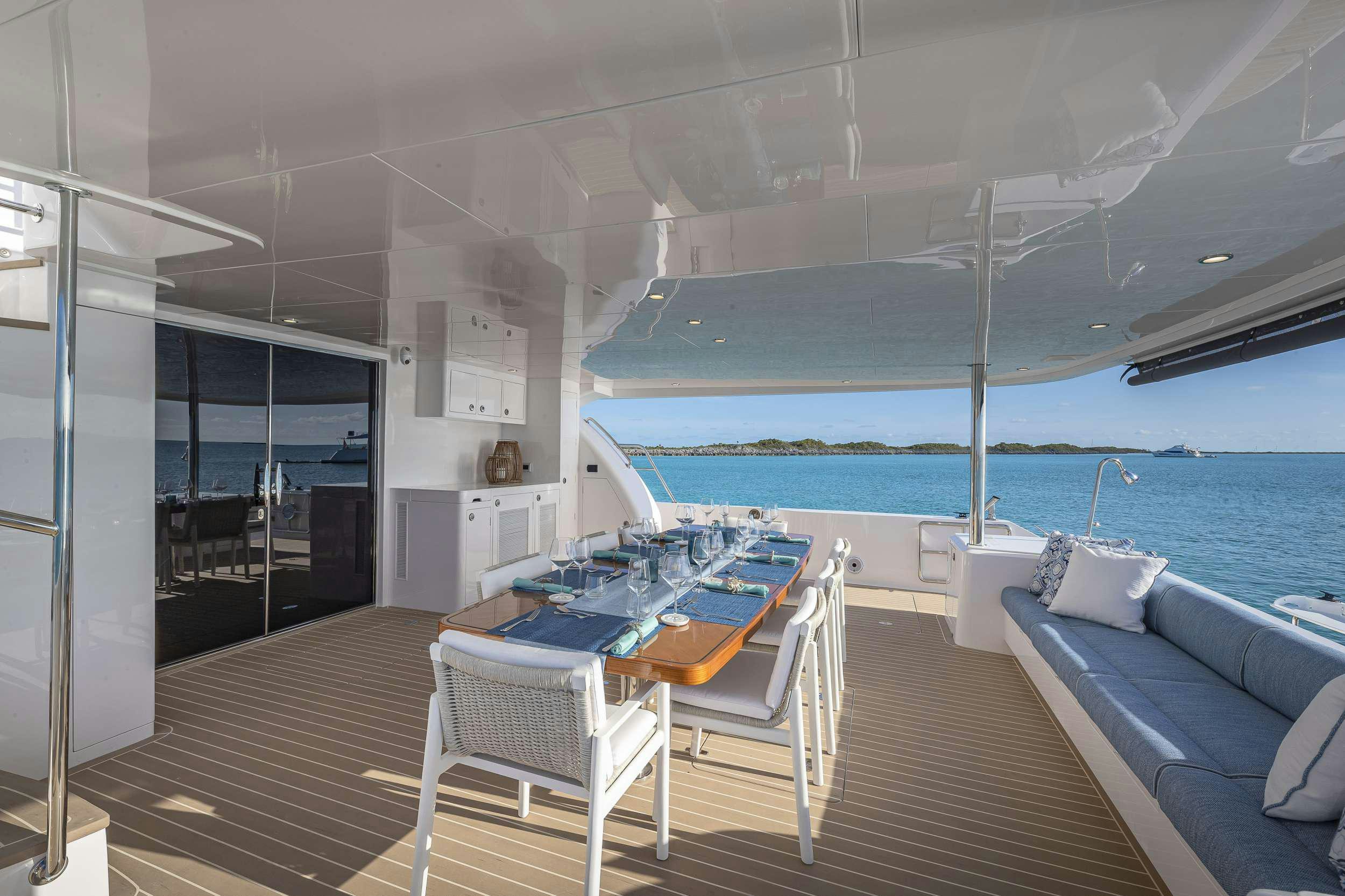 a deck with a pool and a deck with a view of the ocean aboard OMAKASE Yacht for Charter