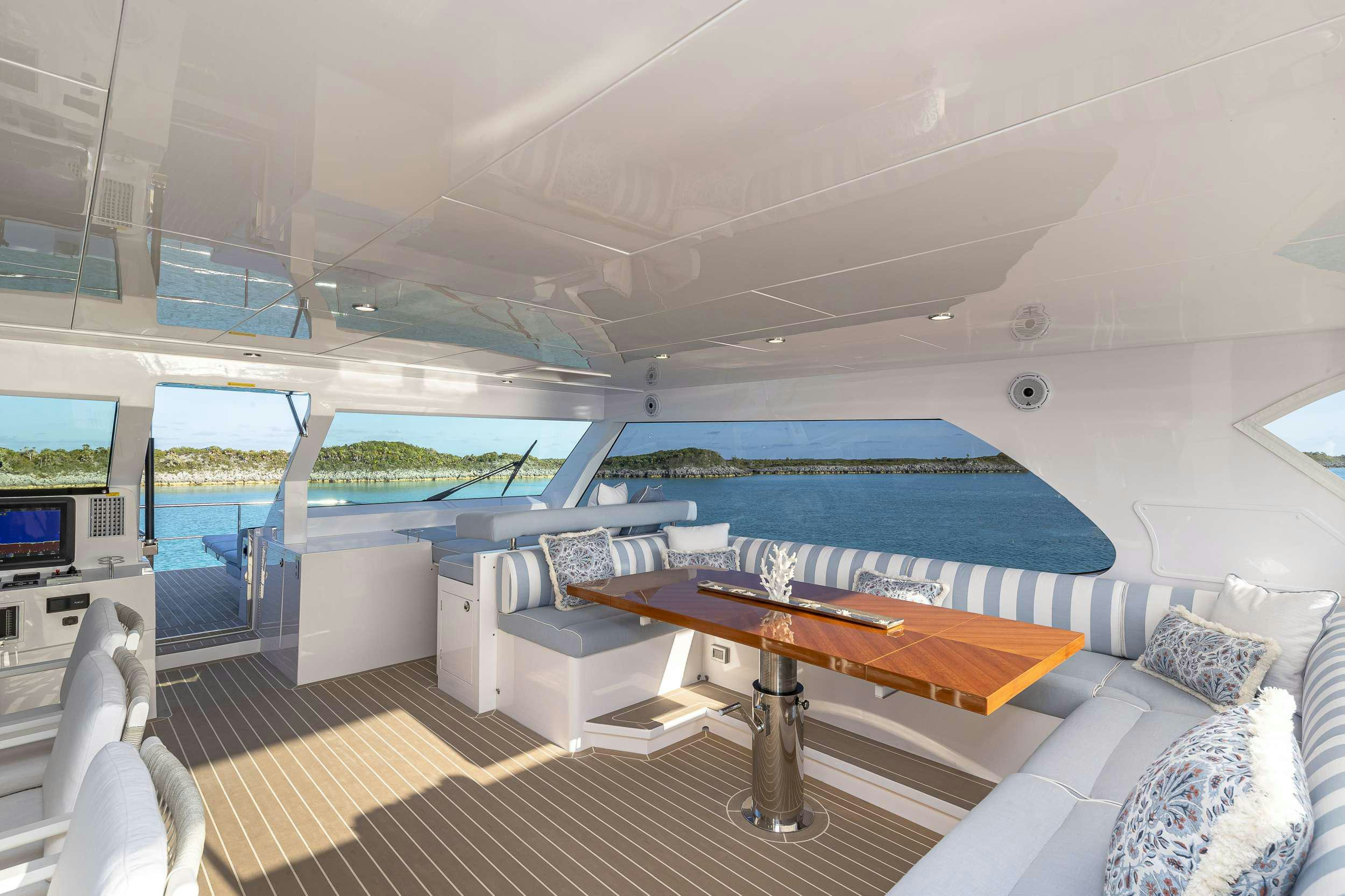 a room with a pool table and couches aboard OMAKASE Yacht for Charter