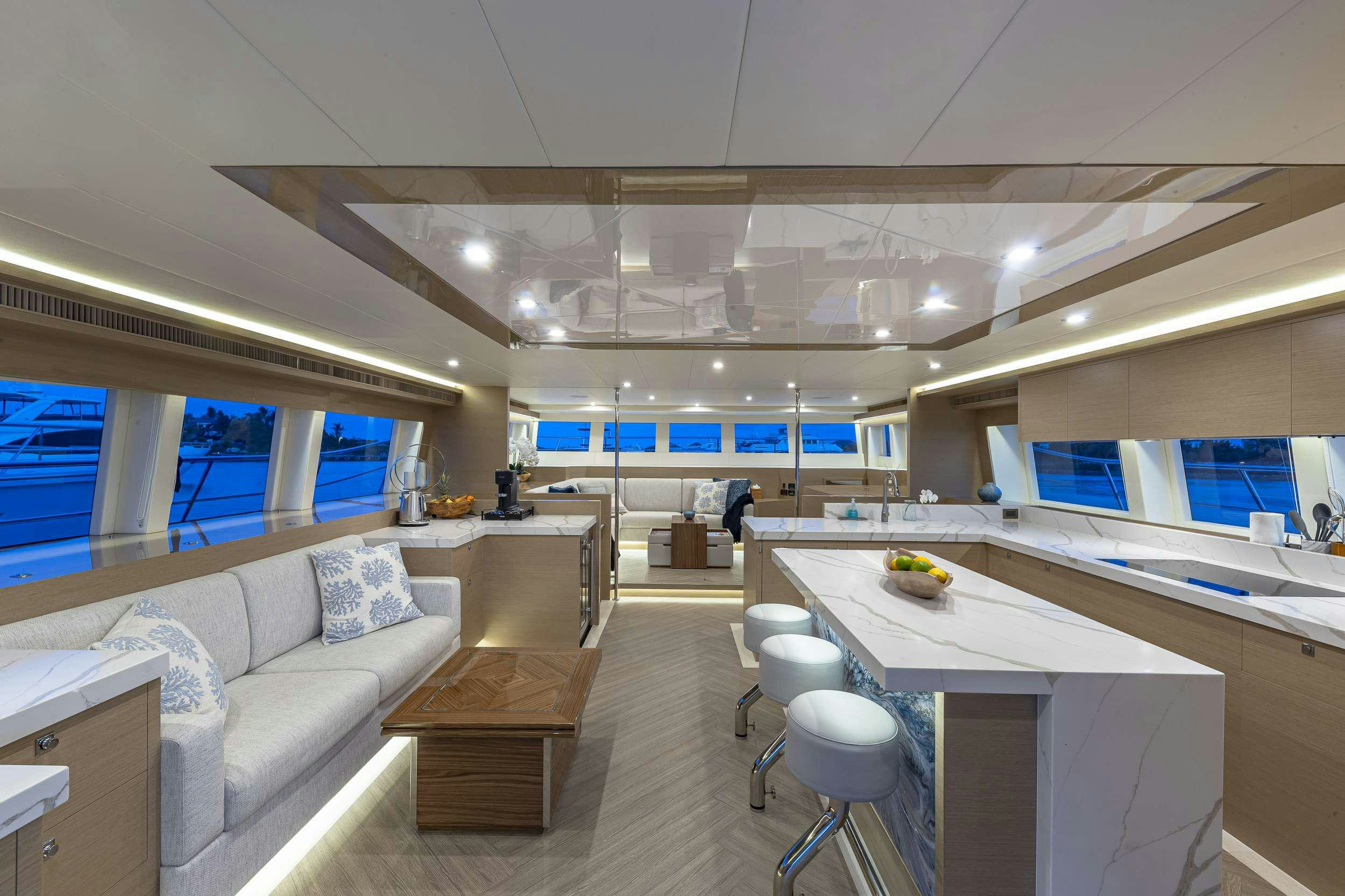 a room with a couch and a table and chairs aboard OMAKASE Yacht for Charter